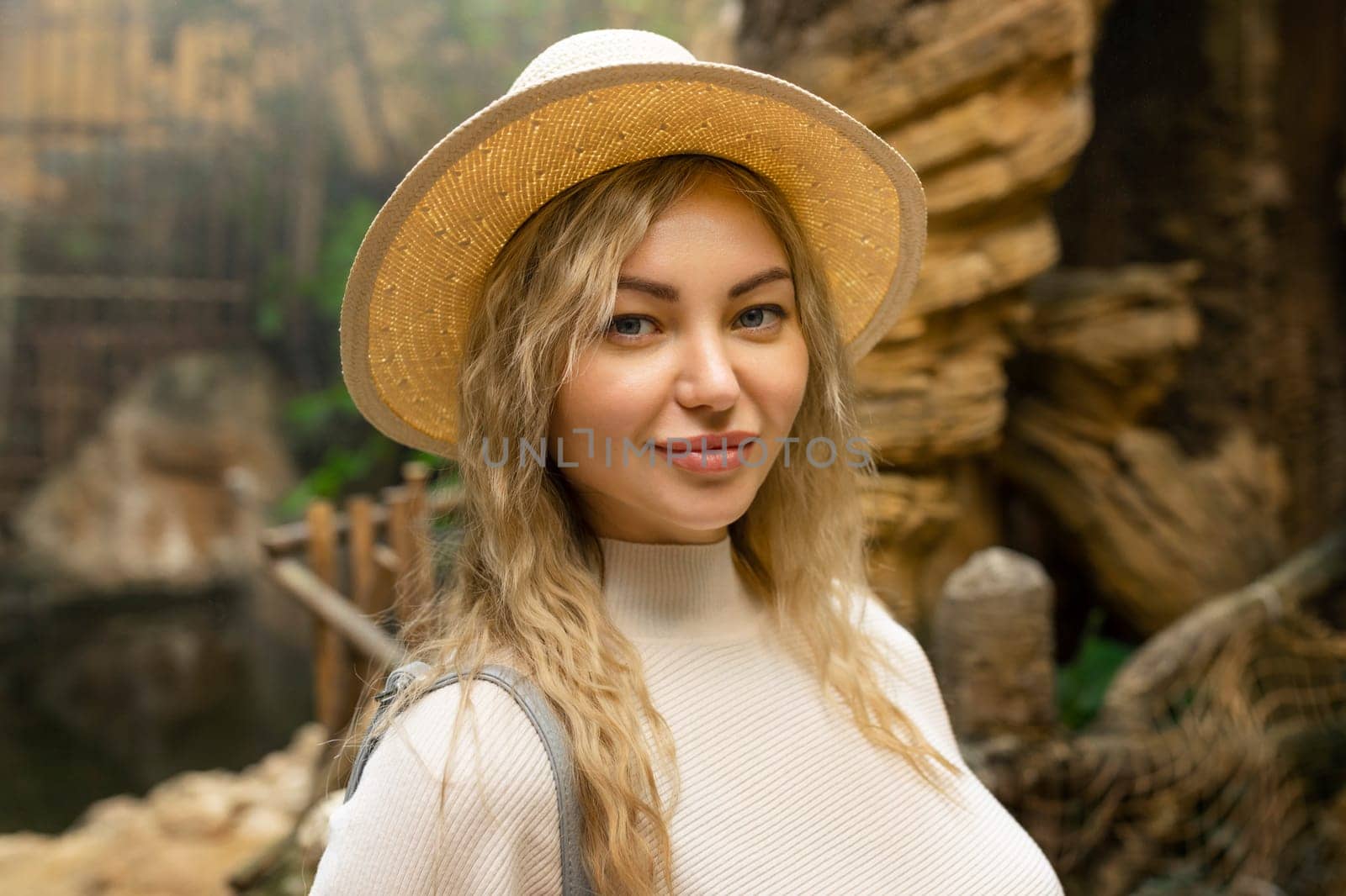 Portrait of a relaxed happy woman in a hat looking at the camera