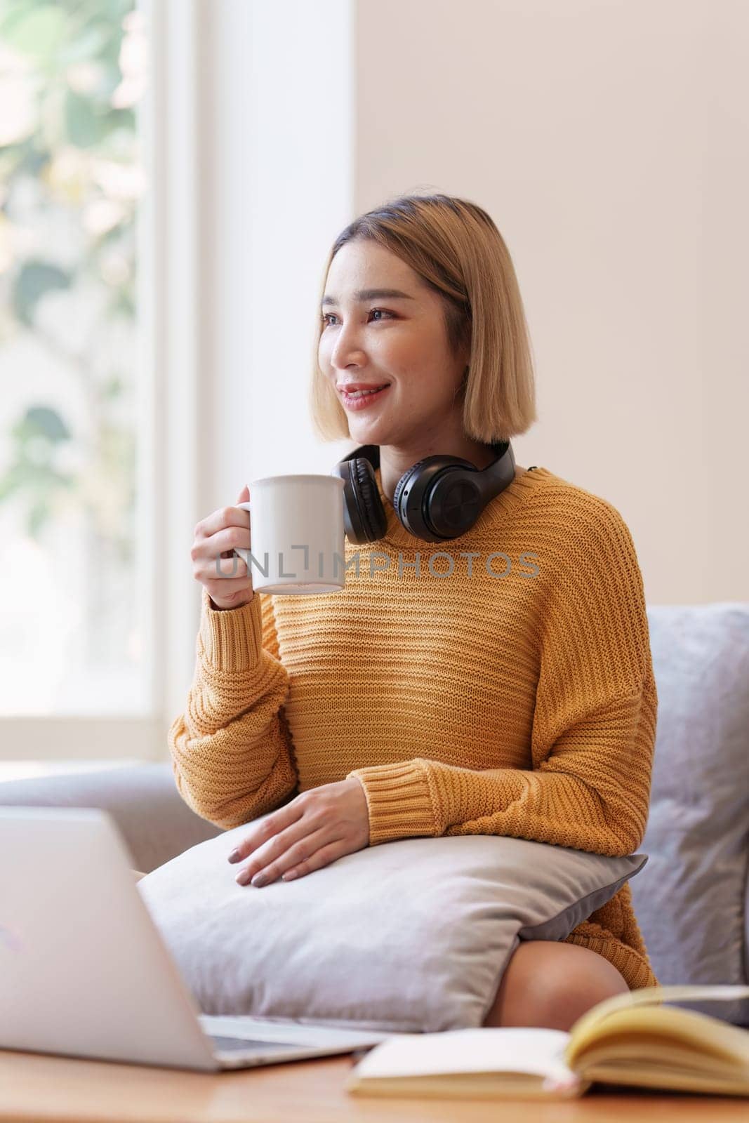 Attractive Asian woman resting comfortable living room and drinking coffee at morning, Relax, Sofa, Lifestyle.
