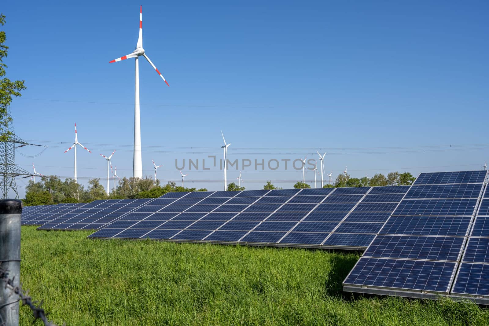 Solar power panels with wind turbines and power lines by elxeneize