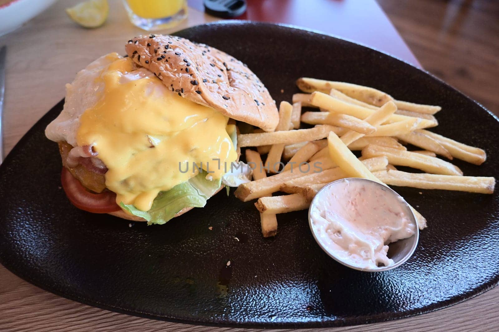 Beef Egg and Bacon Burger Served in Restaurant. American Food. Tasty Gourmet on Wooden Table.