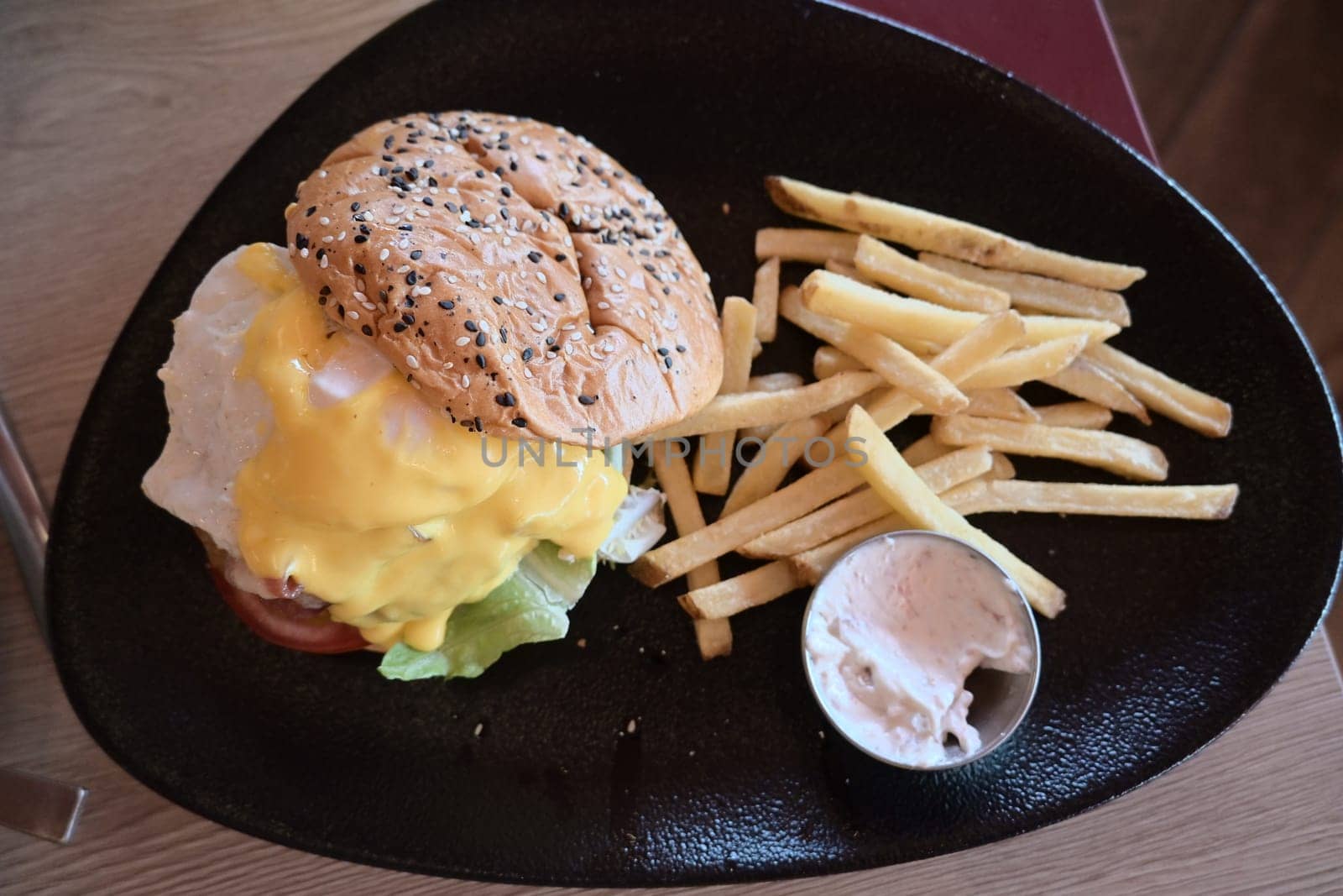 Beef Egg and Bacon Burger Served in Restaurant. American Food. Tasty Gourmet on Wooden Table.