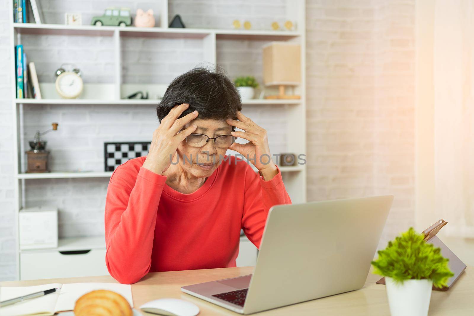 Senior woman depression and serious about checking Bitcoin price chart on digital exchange on laptop by Wmpix