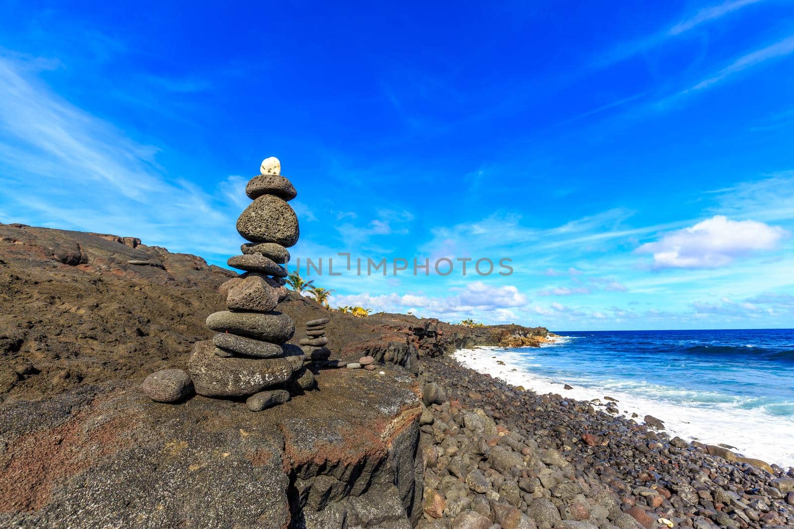 Black stone Cairn (ahu) at Kaimu beach park, Big Island, Hawaii.