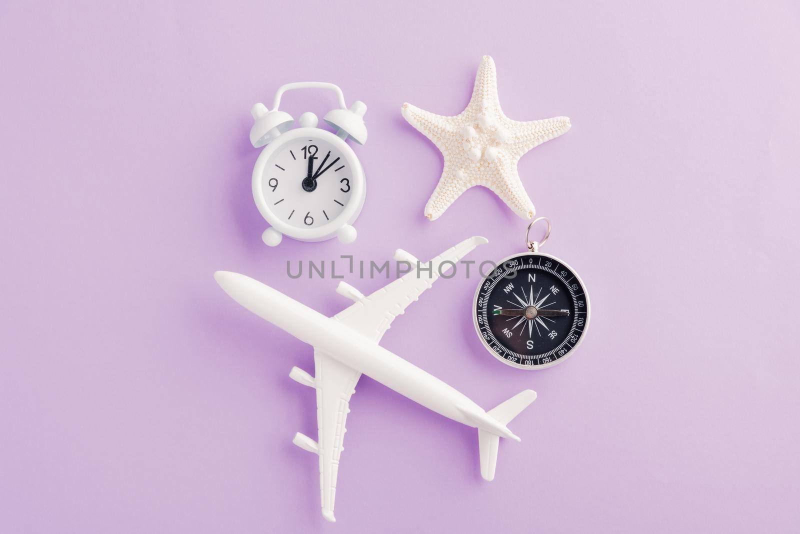 model plane, airplane, starfish, alarm clock and compass by Sorapop