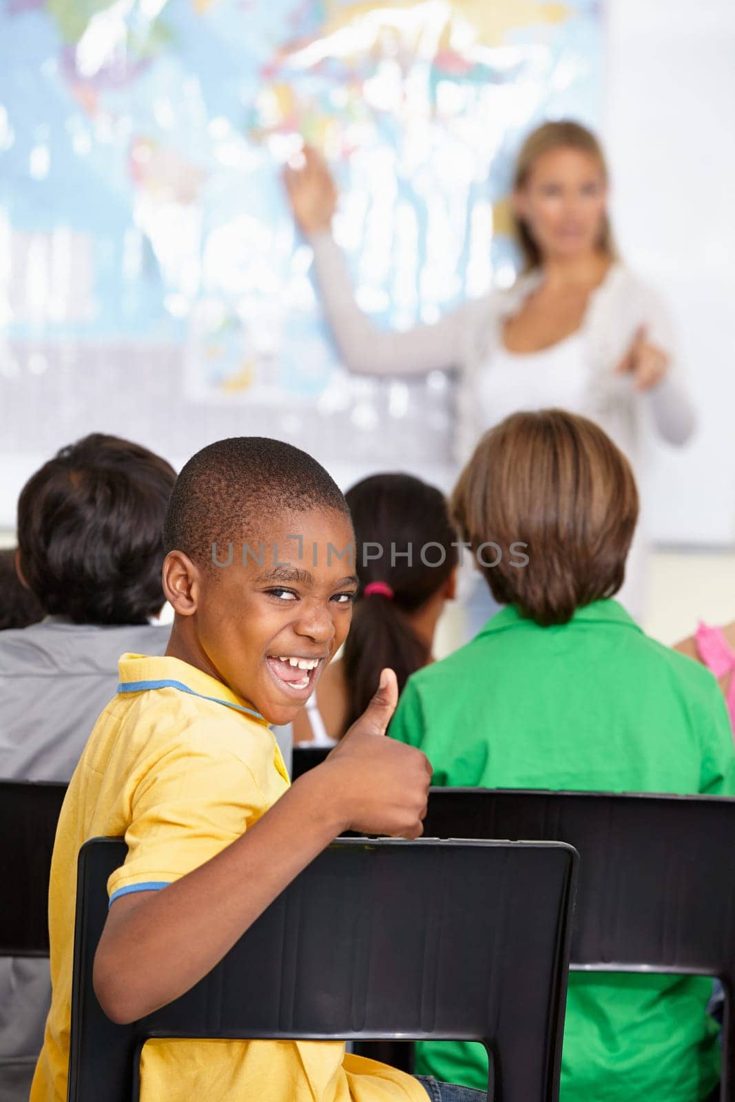 Black child, portrait and thumbs up of student in class, elementary school or classroom. Funny, education and kid with hand gesture for like emoji, agreement or learning, success and approval sign. by YuriArcurs