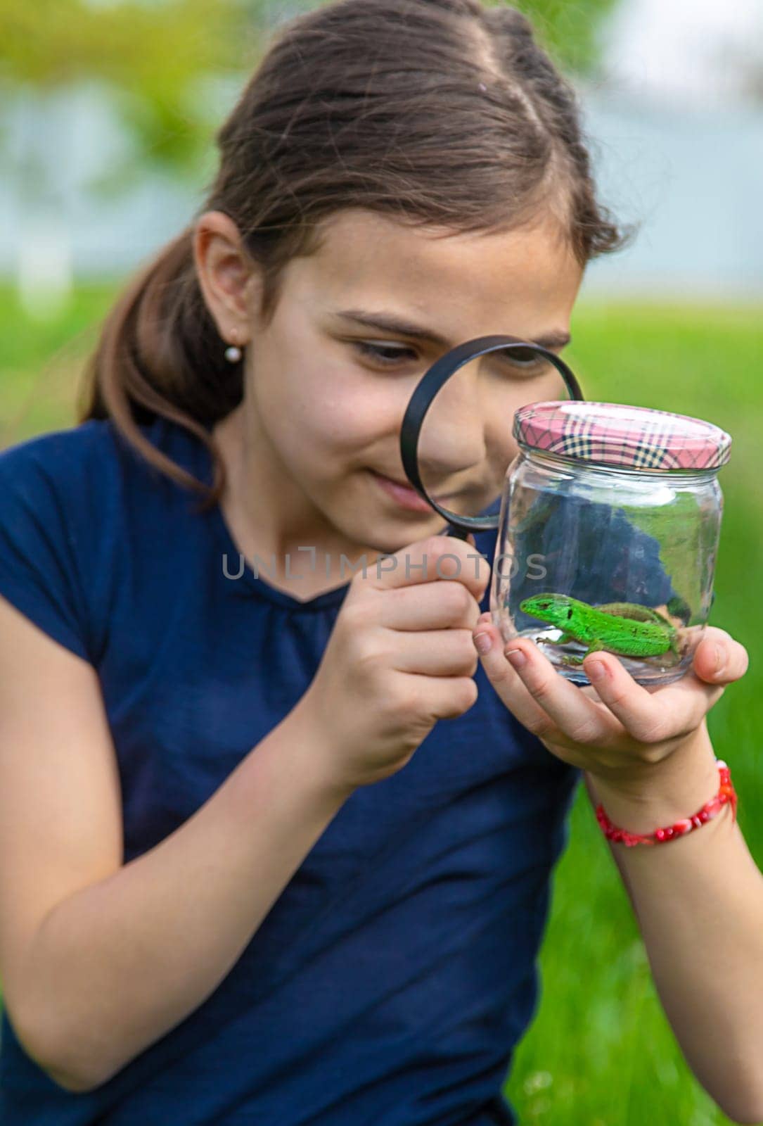 Child in nature with a lizard. Selective focus. Kid.