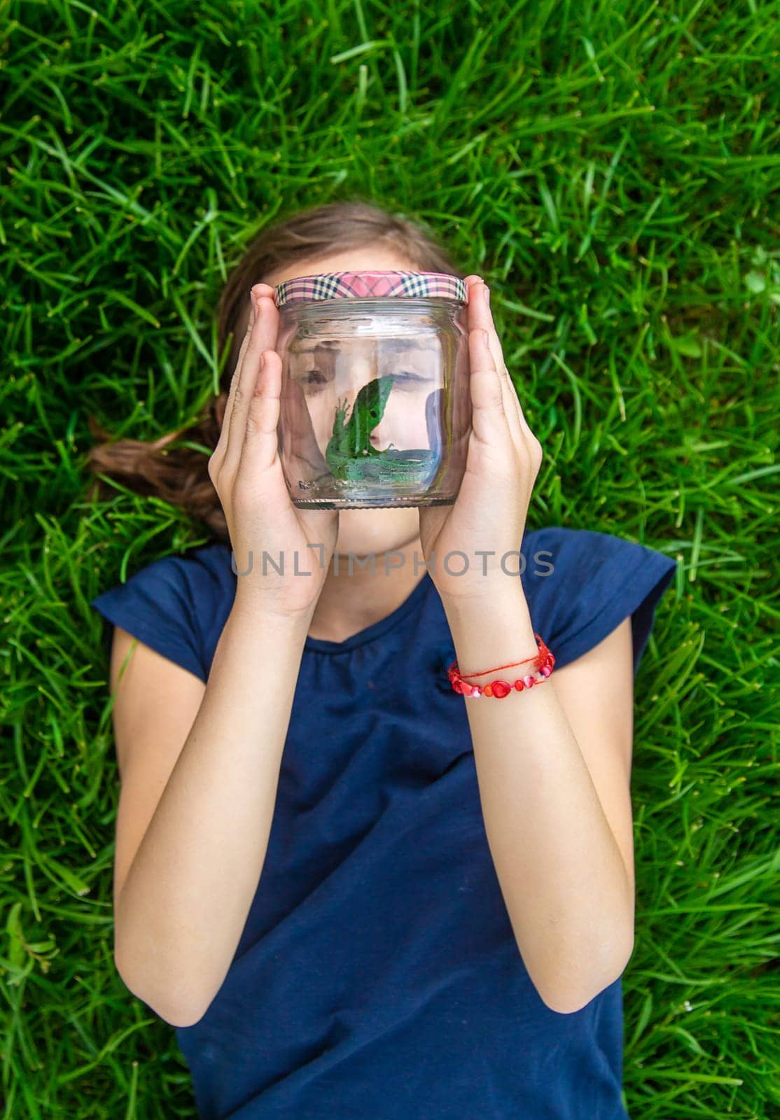 Child in nature with a lizard. Selective focus. Kid.