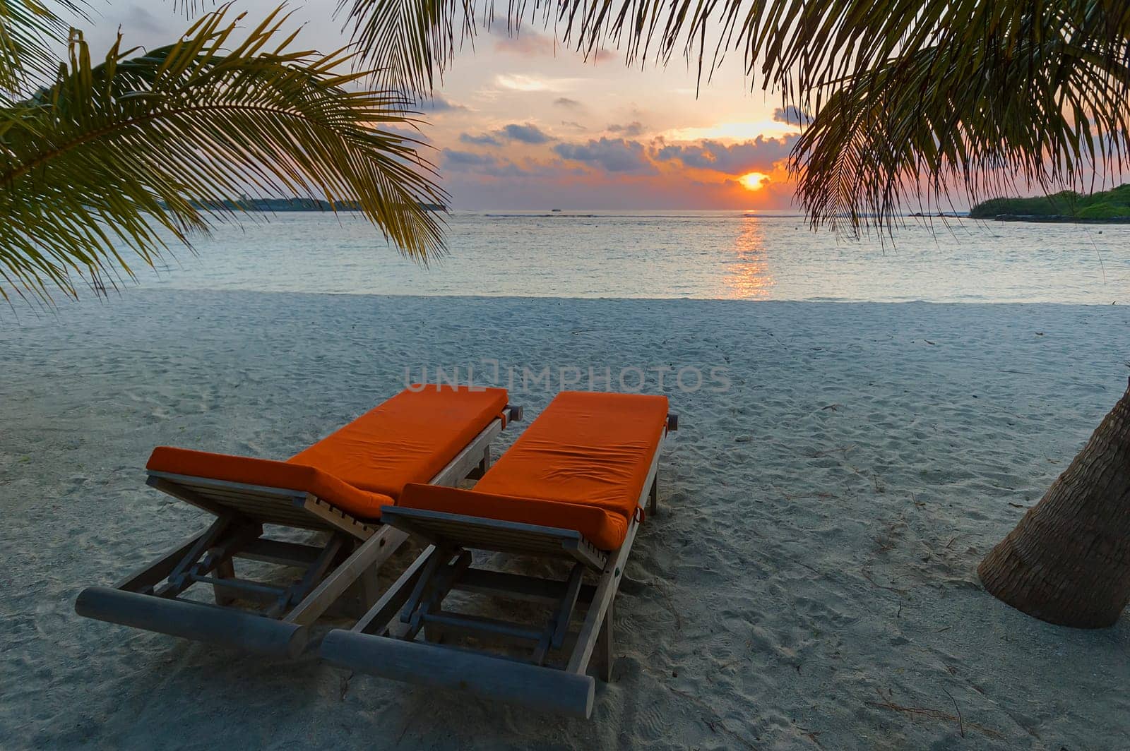 Colorful sunset on an island in the Maldives in the Indian Ocean