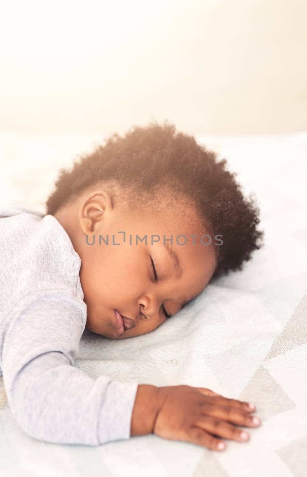 Cute, bed and baby sleeping in home on blanket for rest, nap time and dreaming in nursery. Childcare, newborn and adorable, tired and African child in bedroom sleep for comfort, relaxing and calm.