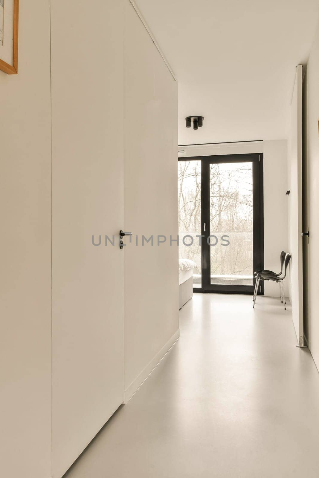 a room with white walls and a sliding glass door by casamedia