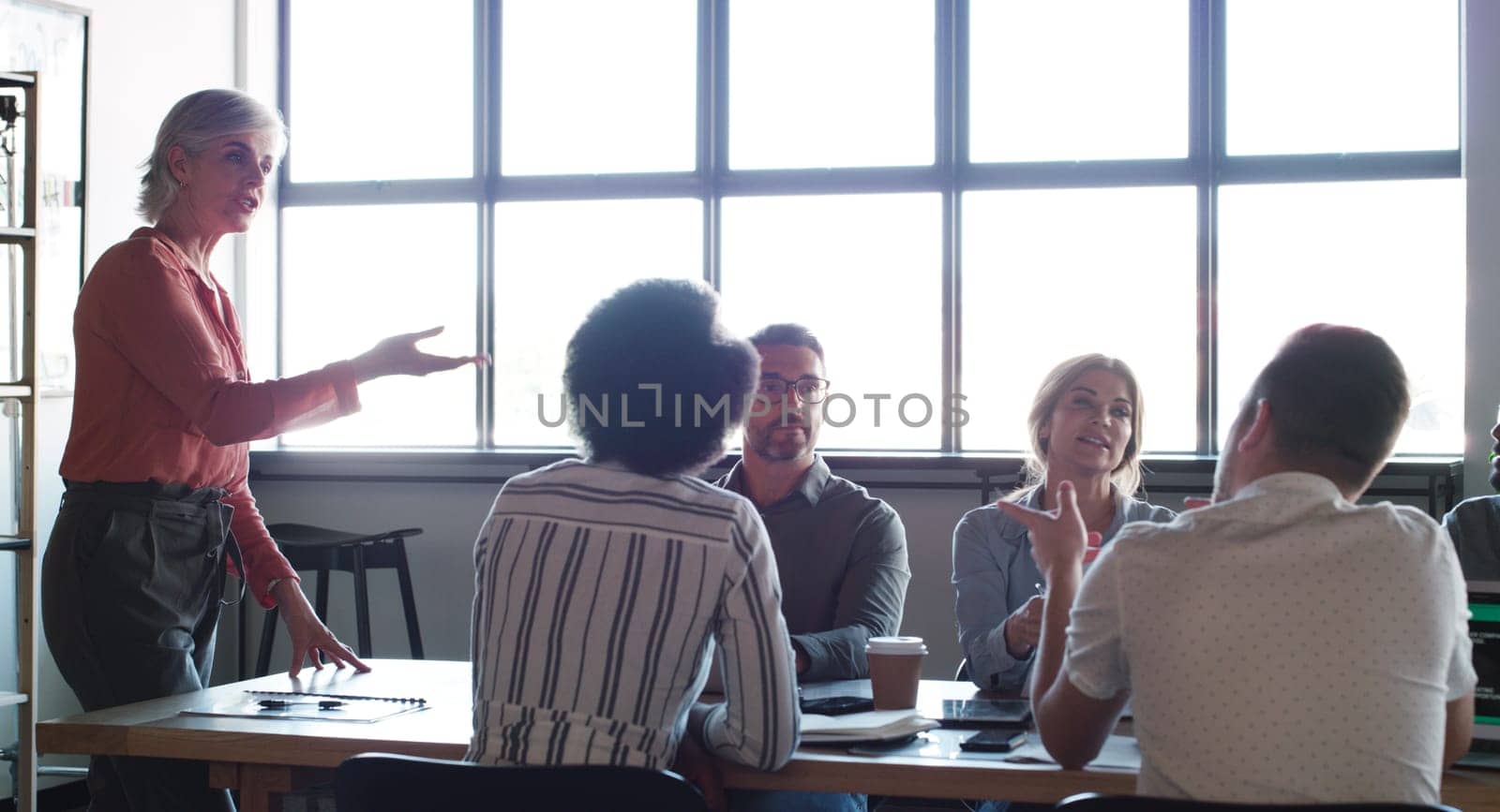 Clear communication keeps a meeting on track. a group of businesspeople having a meeting in a modern office