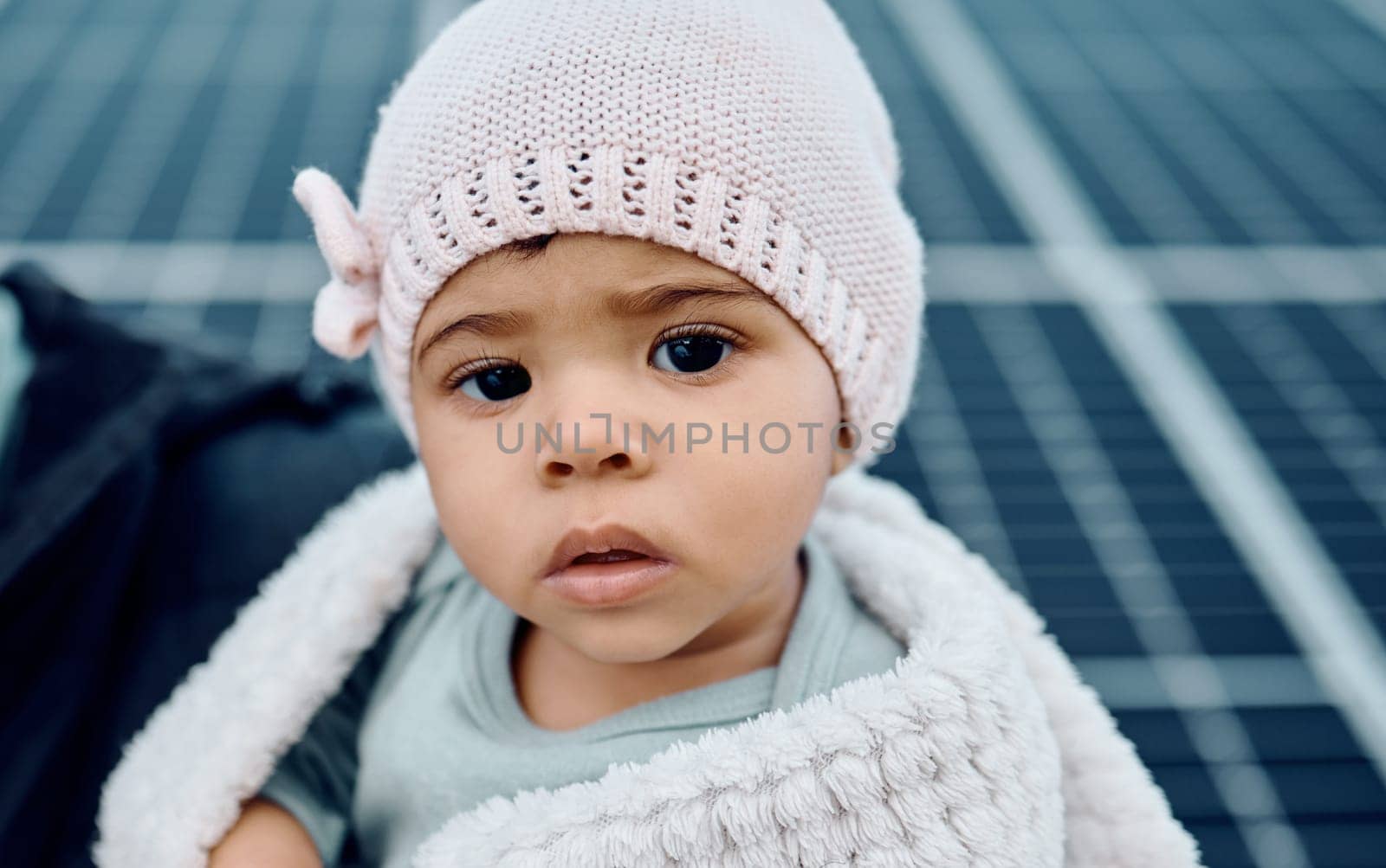 Portrait, baby and beanie with a girl child in a blanket during winter looking cute or adorable. Children, babies and face with a small female kid feeling curious or serious while keeping warm by YuriArcurs