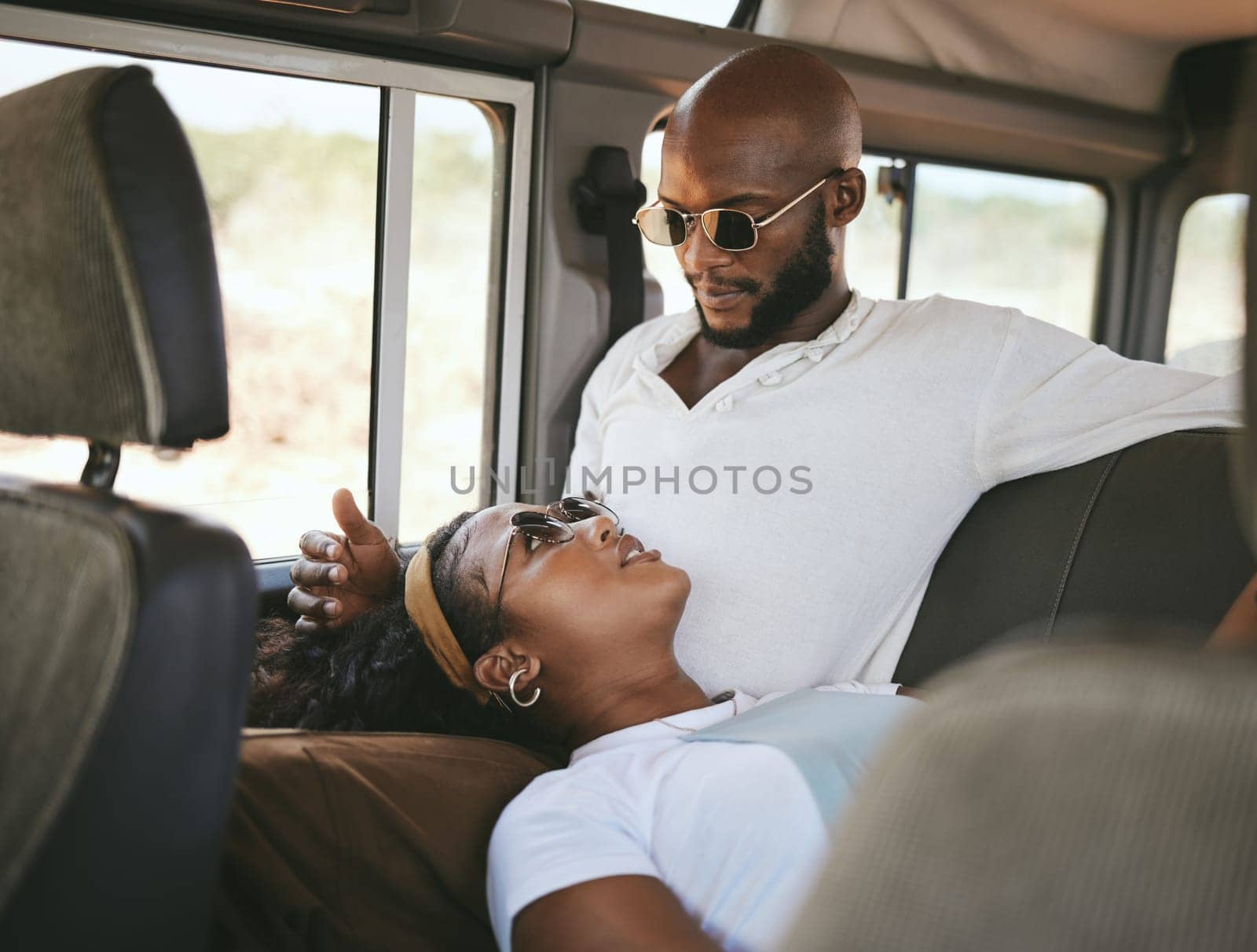Couple, car and travel in nature for road trip, vacation or holiday while relax in van. Man, black woman and transportation in countryside, safari or road for adventure, love and together in Kenya.