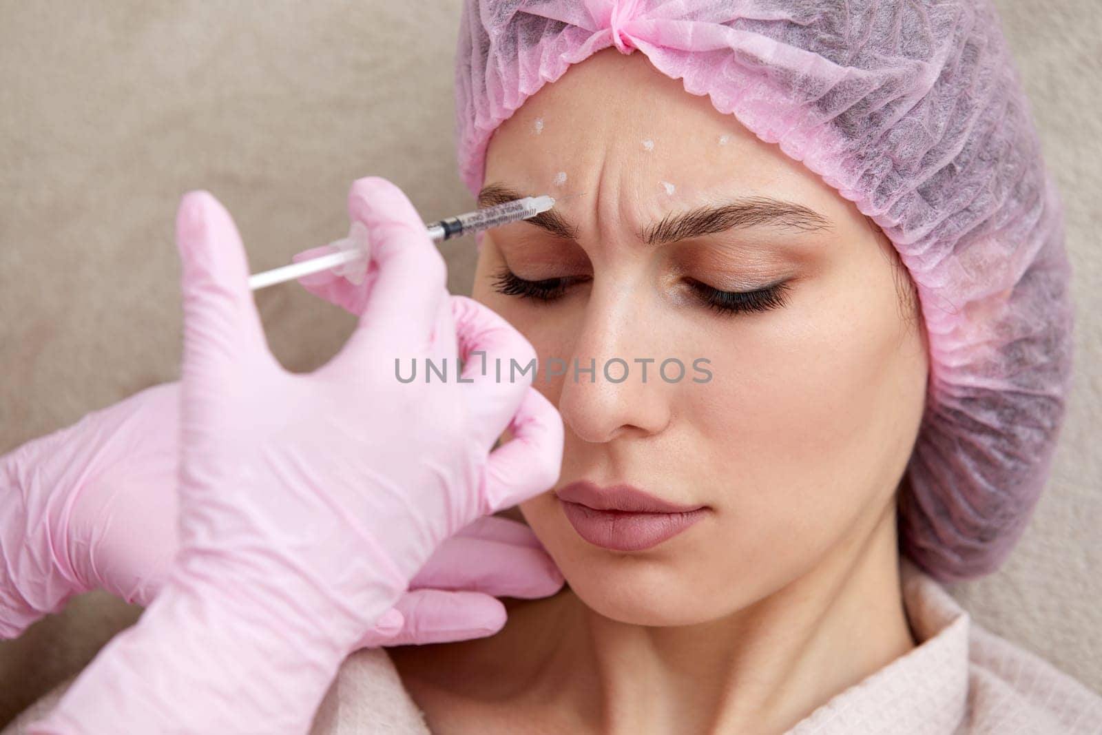 Cosmetologist performs the lift procedure by injecting beauty injections. Doctor injecting hyaluronic acid as facial rejuvenation treatment by Mariakray