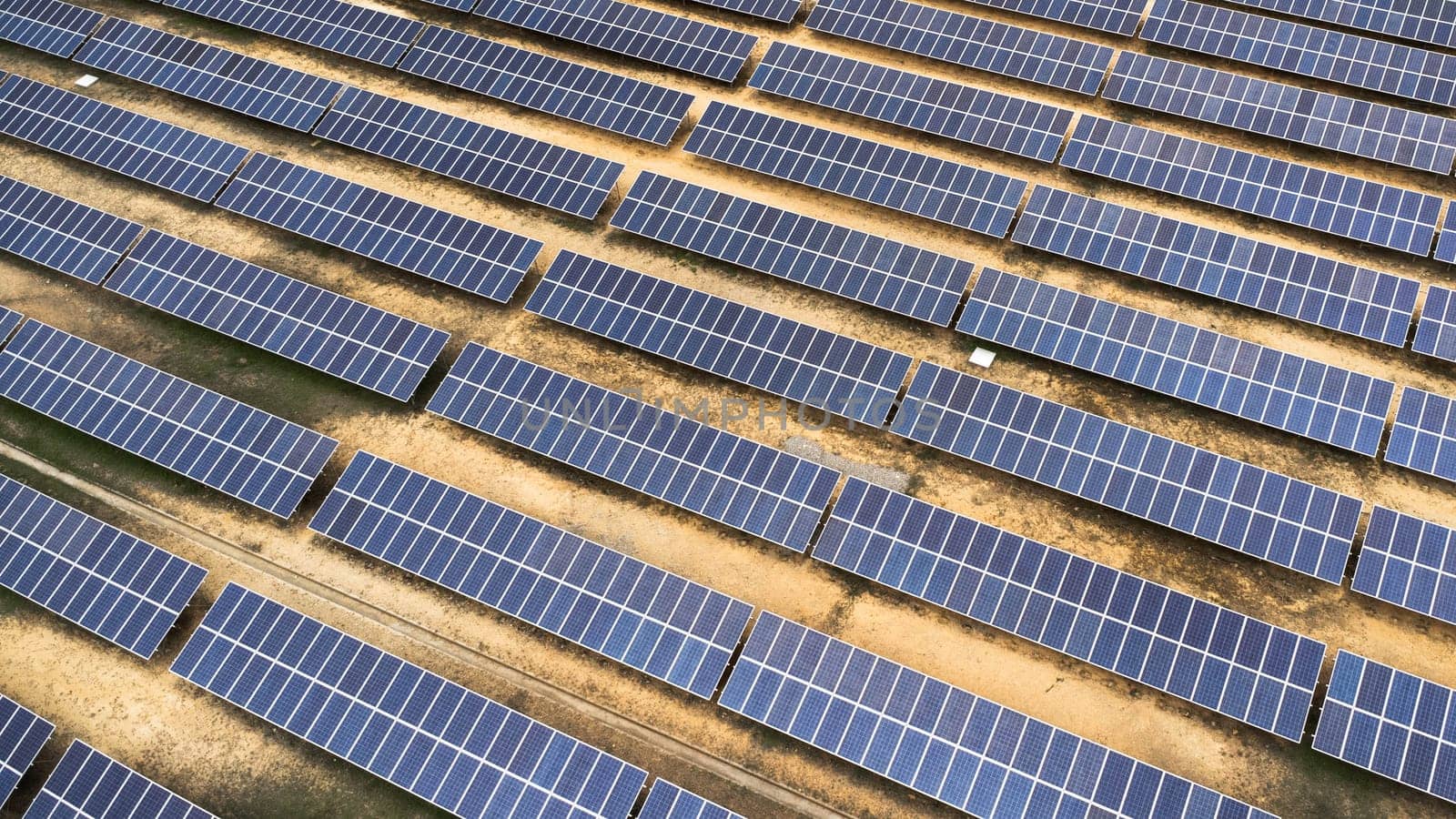 Top view on photovoltaic solar power panels. Drone aerial view of Solar panels system power generators from sun. Alternative Energy Sources - The Concept of Sustainable Resources.