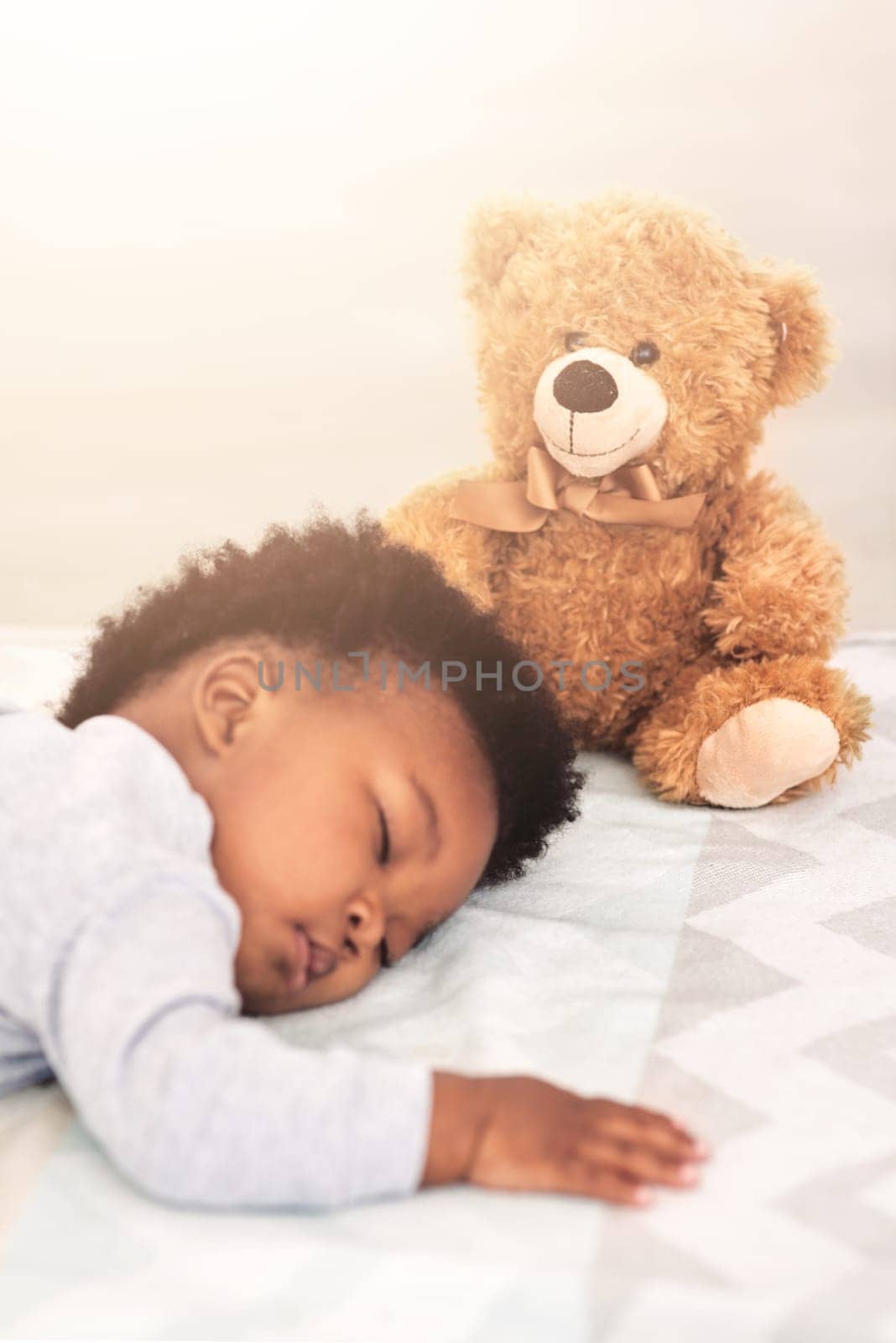Sleeping, teddy bear and tired with baby in bedroom for carefree, development and innocence. Dreaming, relax and comfortable with african infant and toy at home for morning, resting and bedtime.
