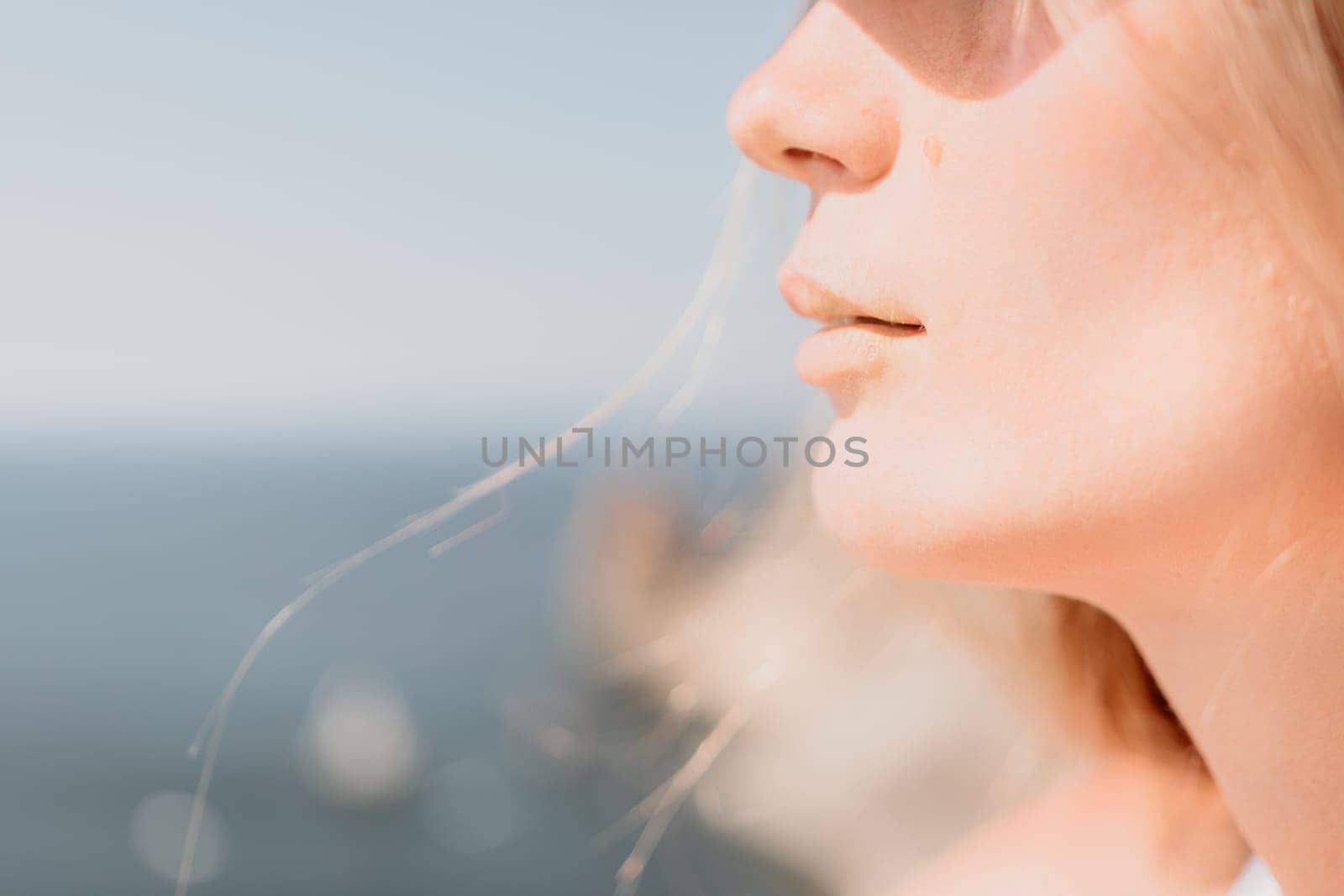 Woman travel sea. Happy tourist in hat enjoy taking picture outdoors for memories. Woman traveler posing on the beach at sea surrounded by volcanic mountains, sharing travel adventure journey by panophotograph