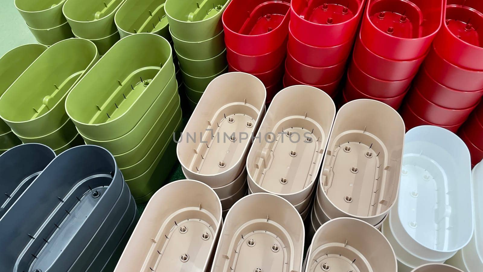 Close-up of empty flower pots in a store or greenhouse. Colorful pots for plants. Gardening and landscape design concept.