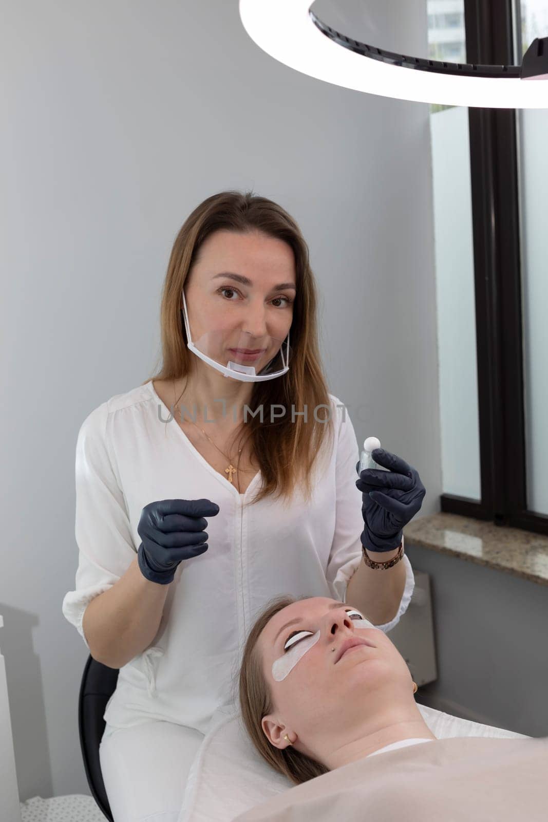 Beautician Holds Bottles With Lash Lift Lotion For Eyelash Lamination Treatment Procedure In Beauty Salon. Curling, Staining, Extension Procedures For Lashes. Vertical Plane. High quality photo
