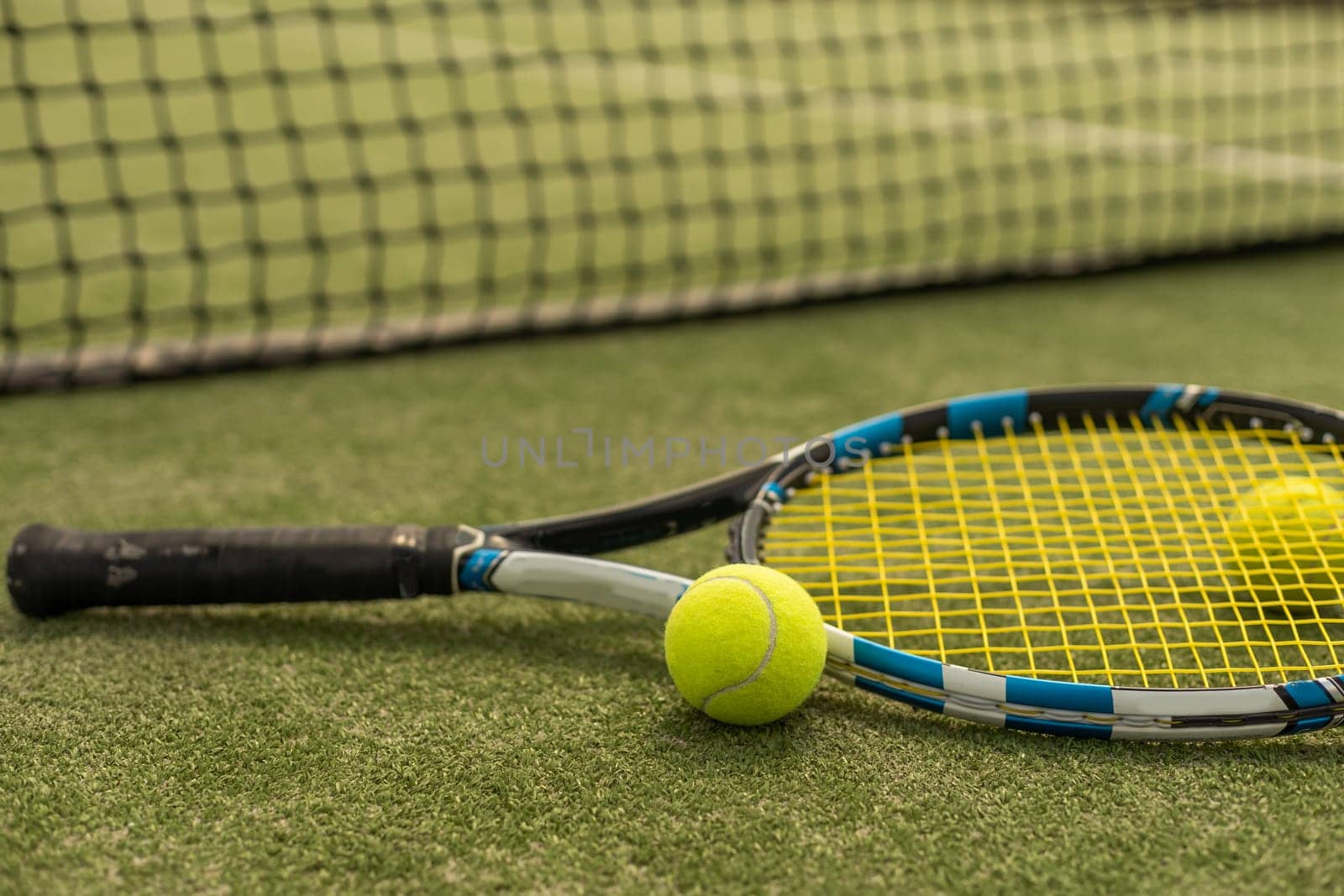 tennis racket with a tennis ball on a tennis court by Andelov13