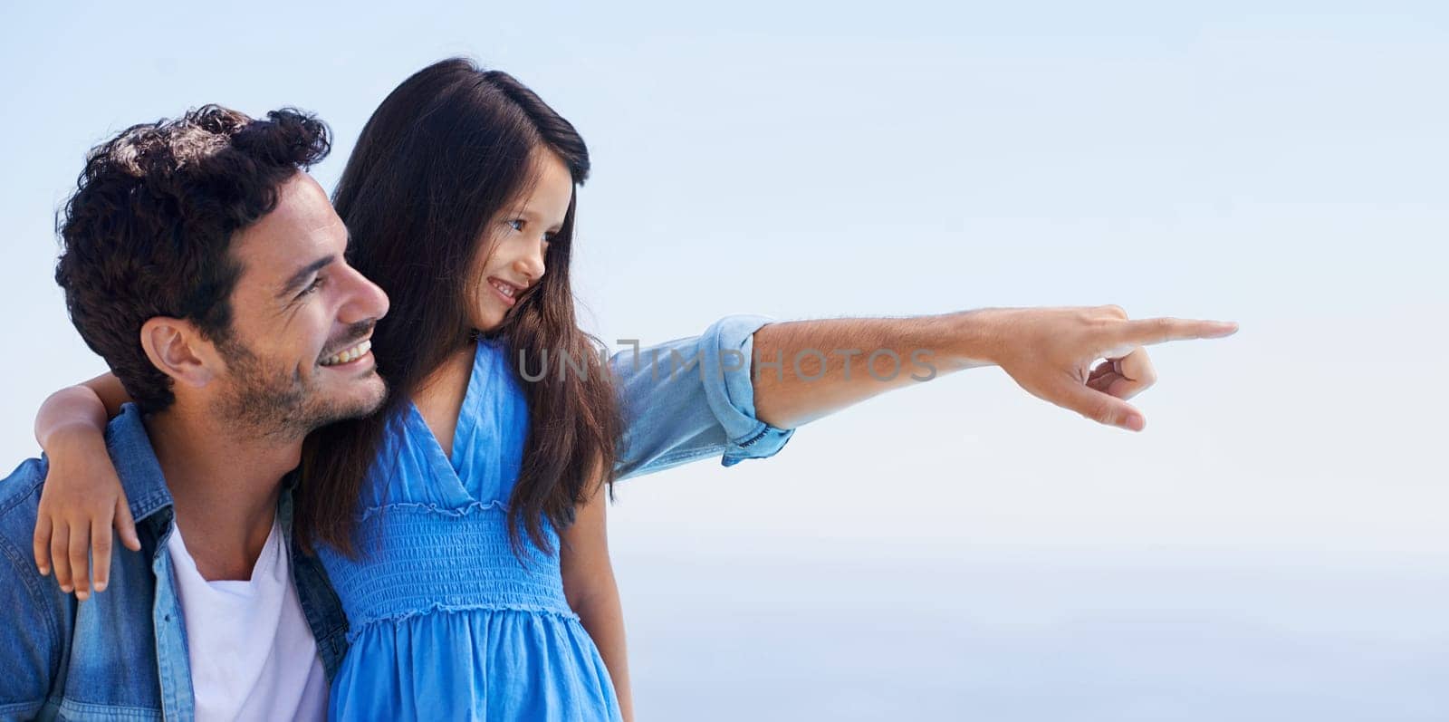 Love, blue sky and happy father, child and pointing at outdoor view, direction and natural freedom. Wellness, peace or relax dad, papa or man bonding, support and care for daughter, girl or youth kid.