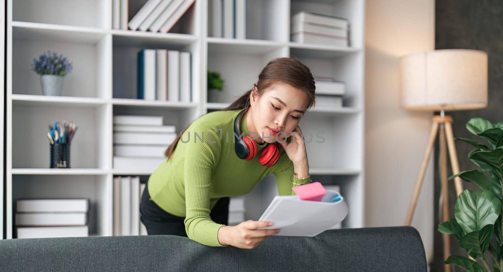 Young woman relaxing and checking document and working work from home by nateemee