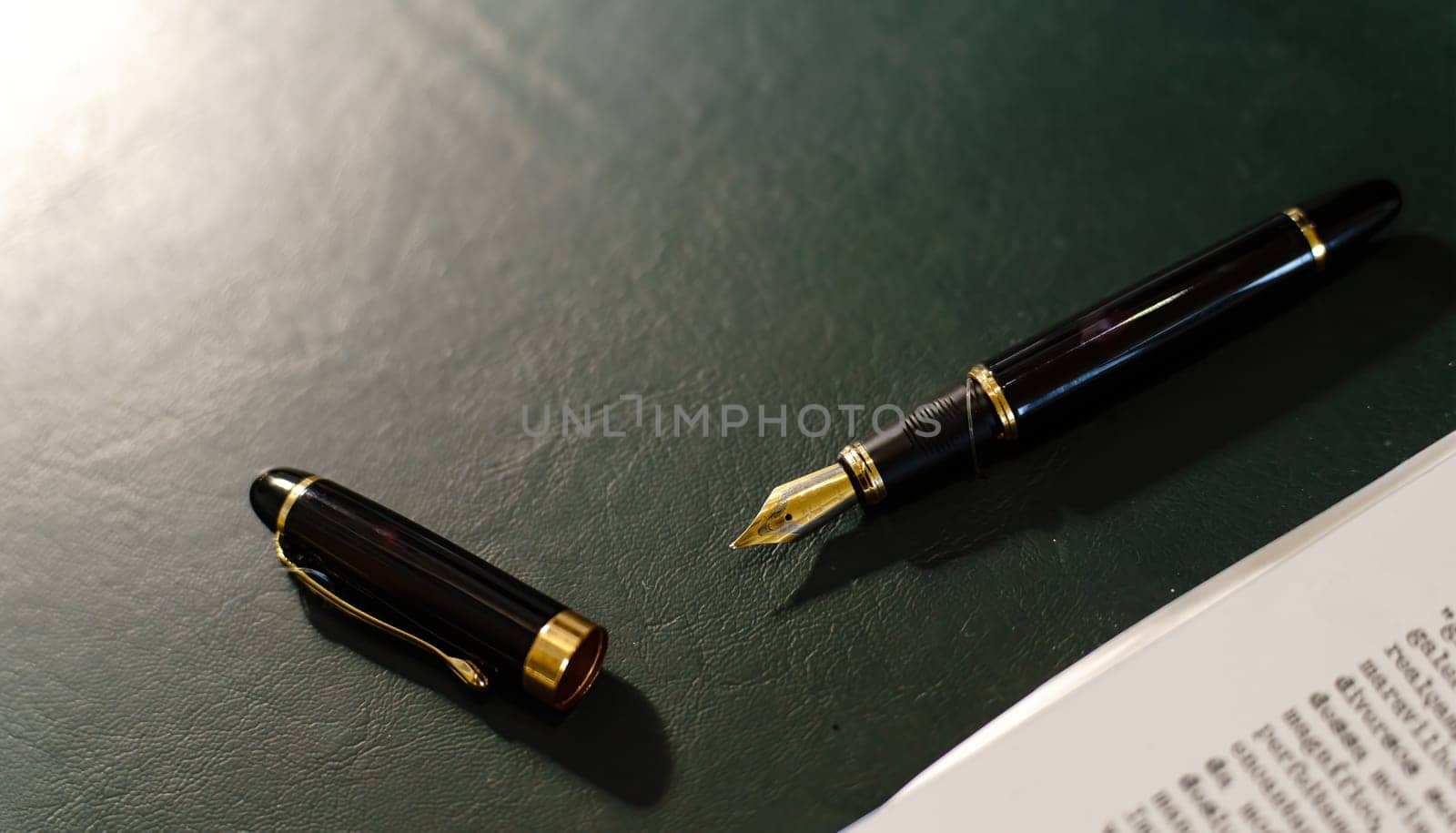 A fountain pen lays open on a desk beside a typed paper, symbolizing the contrast between past and future. The lighting creates shadows and space for text.