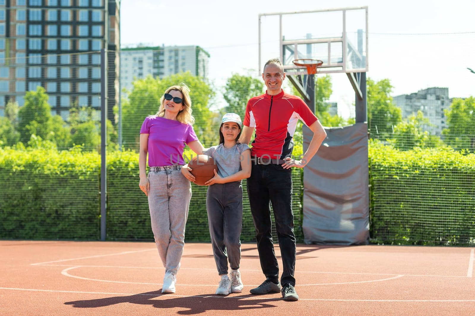 Caucasian family playing basketball together