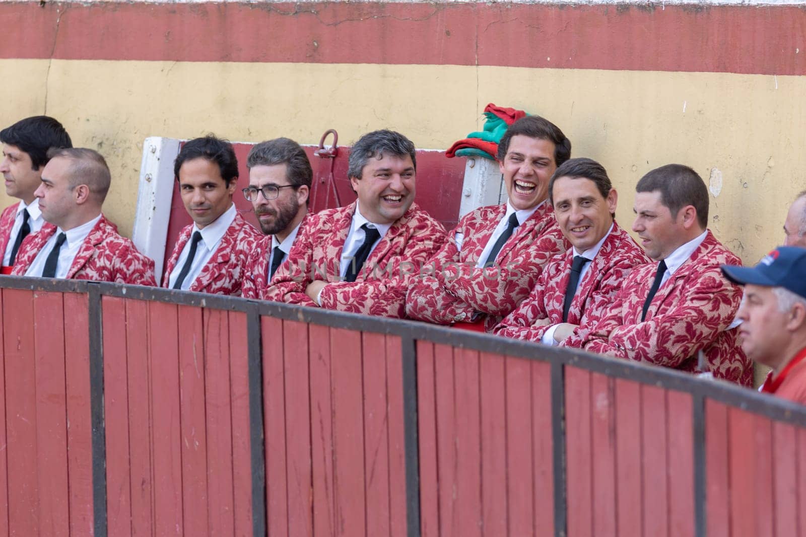 March 26, 2023 Lisbon, Portugal: Tourada - laughing and smiling forcado team by the arena fence. Mid shot