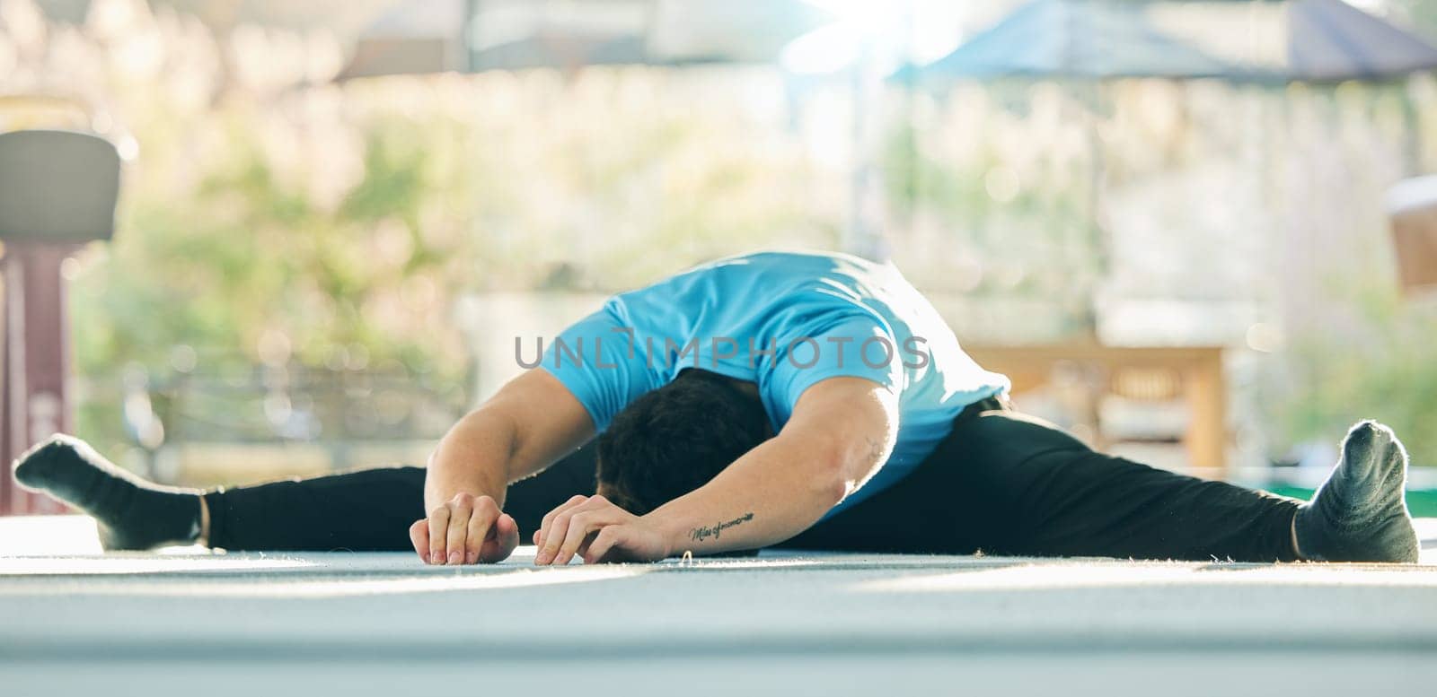 Gymnast stretching, man in gym with fitness and flexibility, professional athlete with gymnastics and training. Exercise studio, warm up and active lifestyle, workout with male in gymnasium and sport.