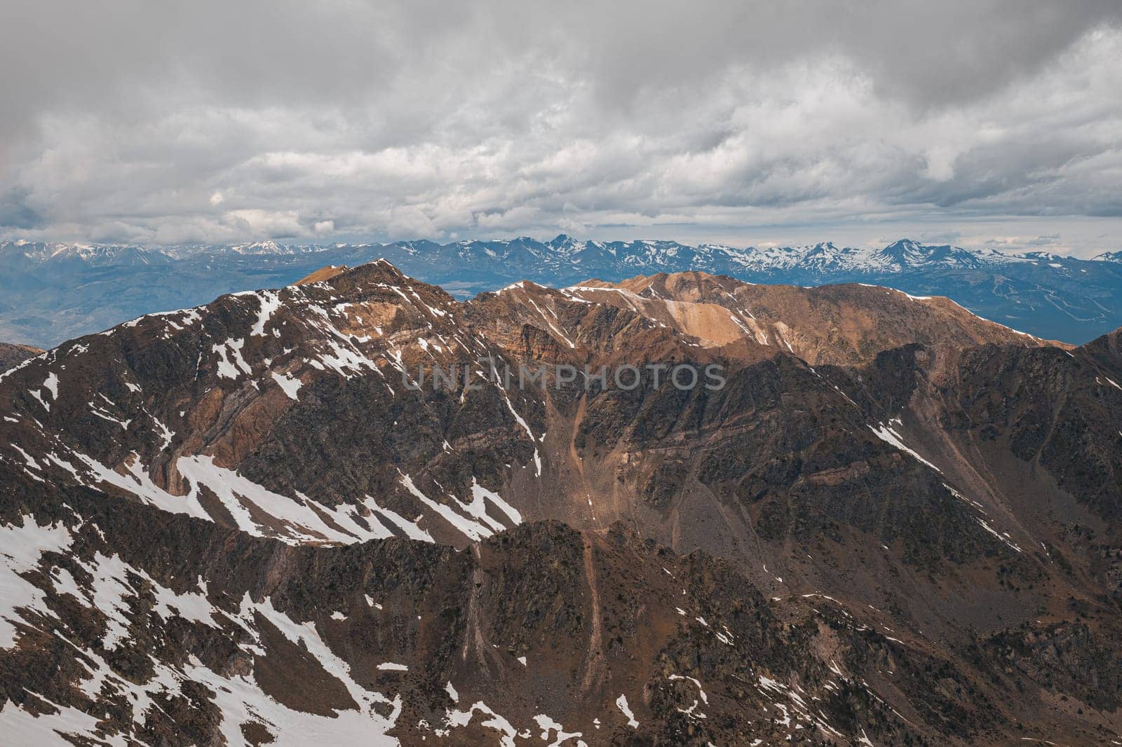 Horizontal shot of mesmerizing view of the snow-covered slopes on a cloudy winter day in the Pyrenees mountains. The concept of beautiful mountainous Spanish nature for travel.