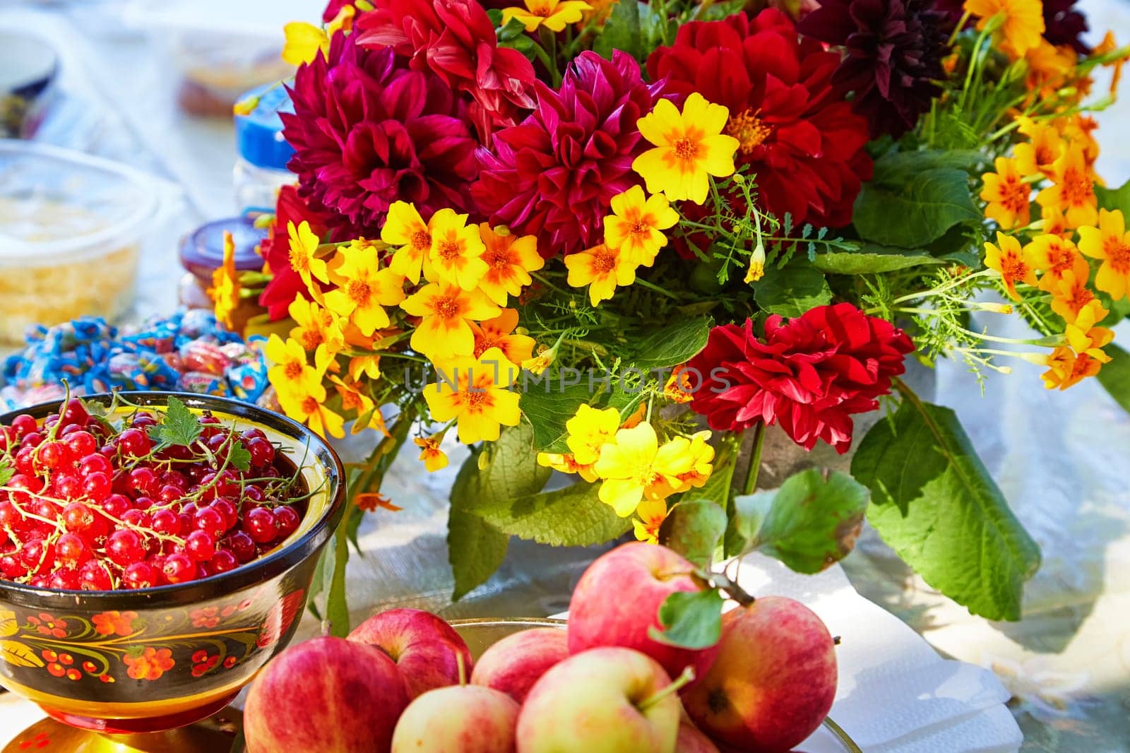 Set table in summer with apples, red currants, flowers. The concept of proper nutrition in summer