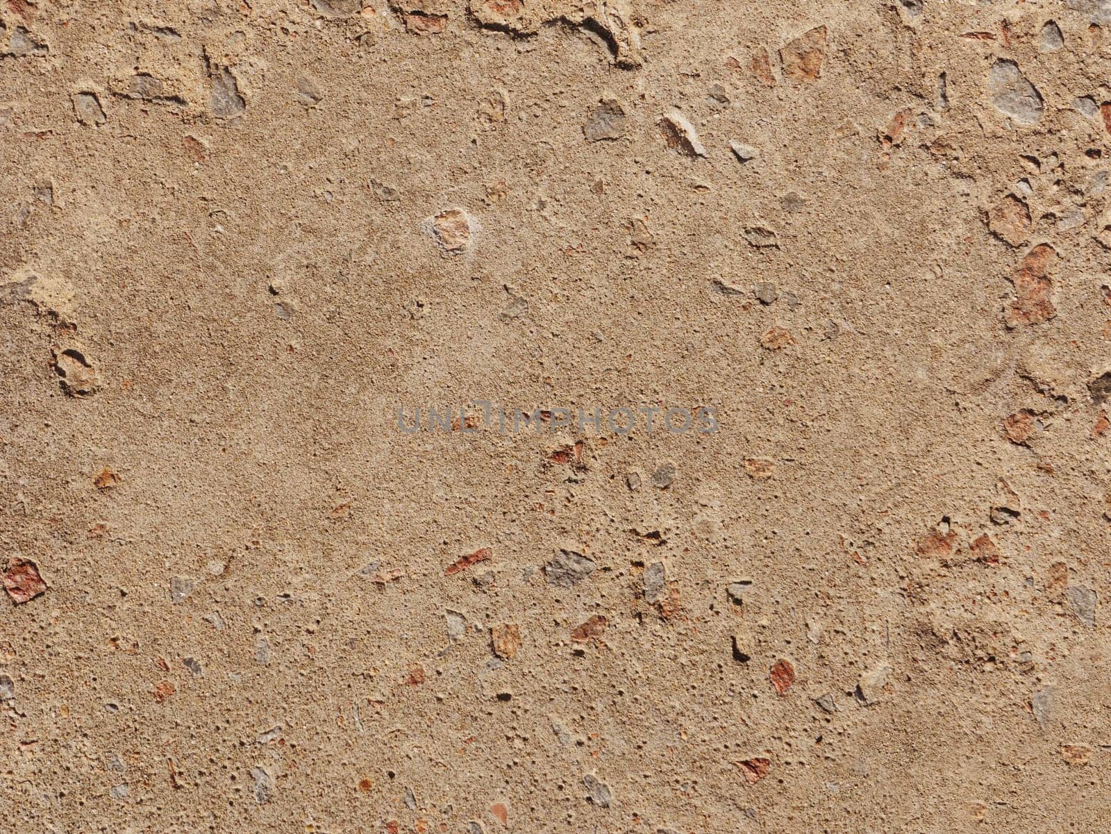 Abstract background made of concrete wall. Rough light brown concrete wall close-up.