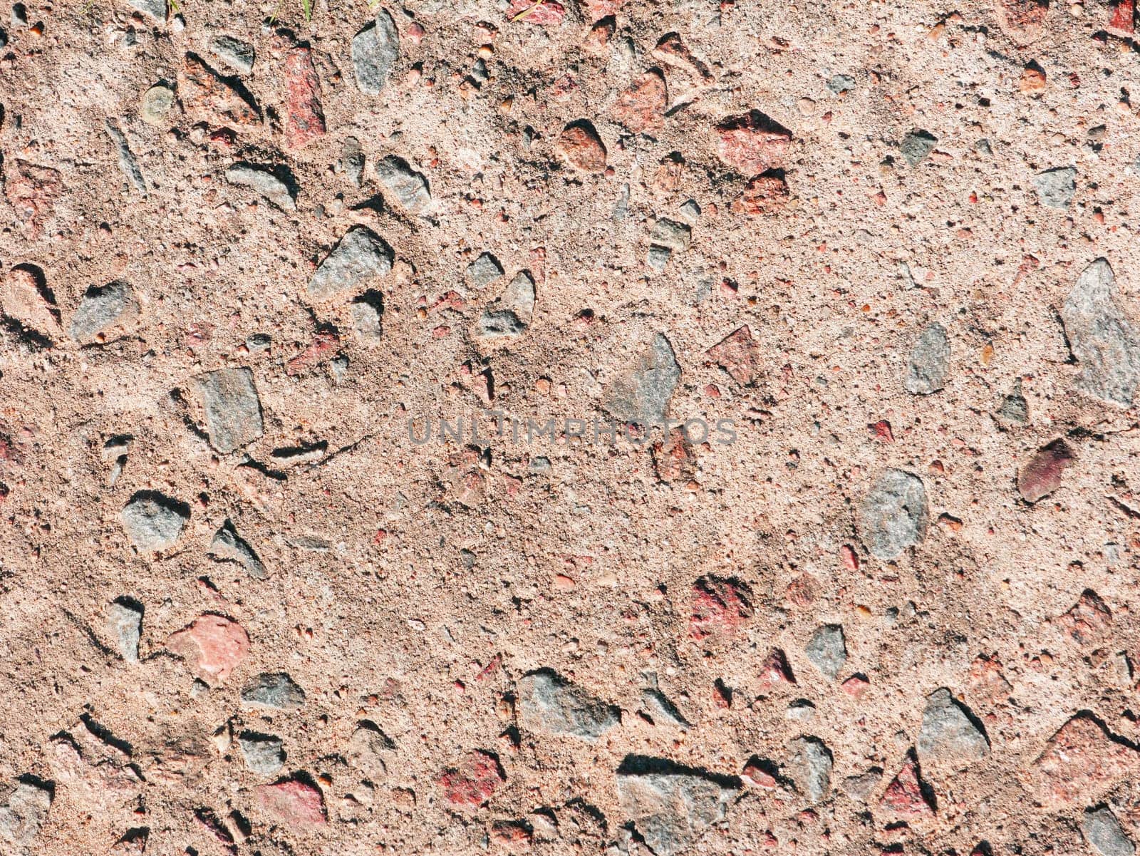 cement wall background. A fragment of an old red concrete wall in close-up.