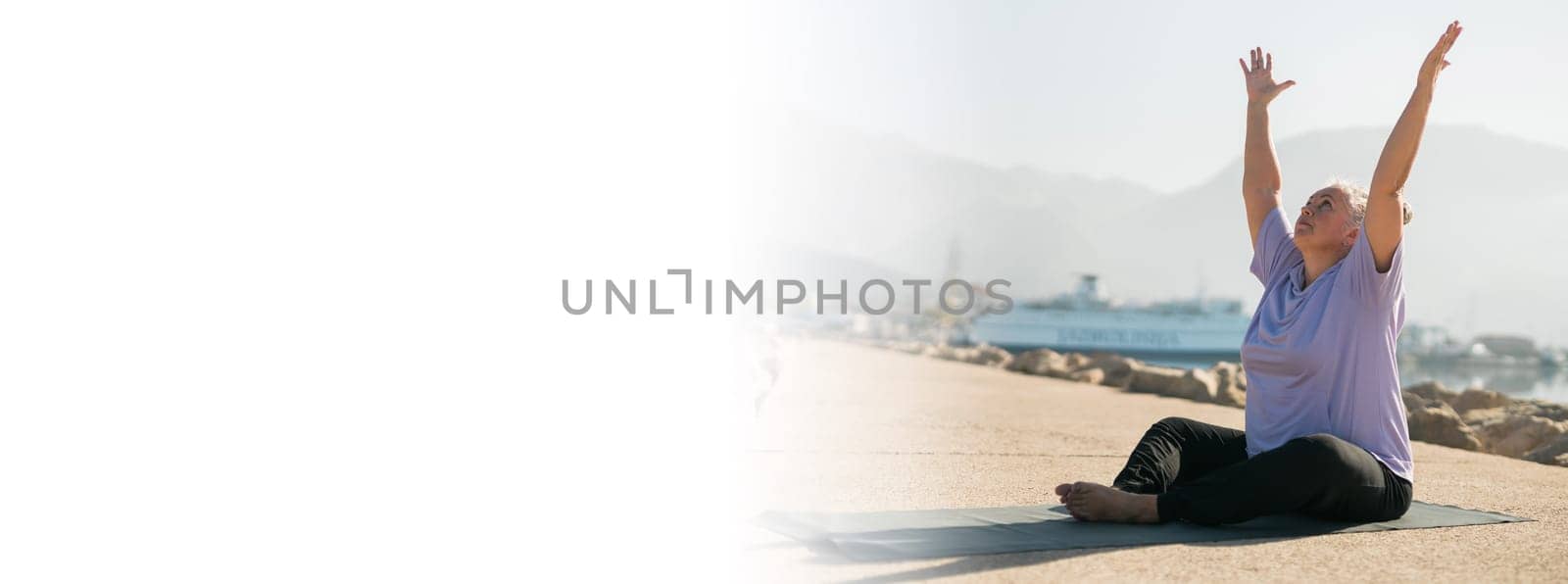 Banner mature woman with dreadlocks working out doing yoga exercises on sea beach copy space - wellness well-being and active elderly age concept by Satura86