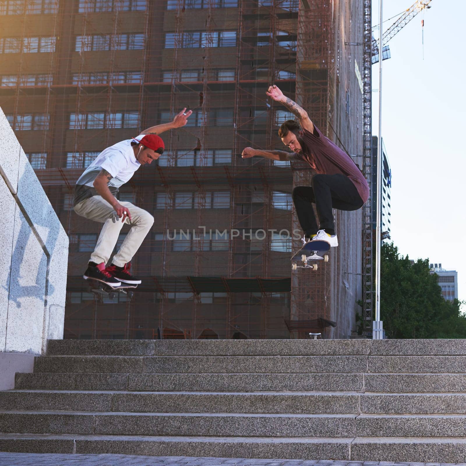 It always seems impossible until its done. two young men skating in the city
