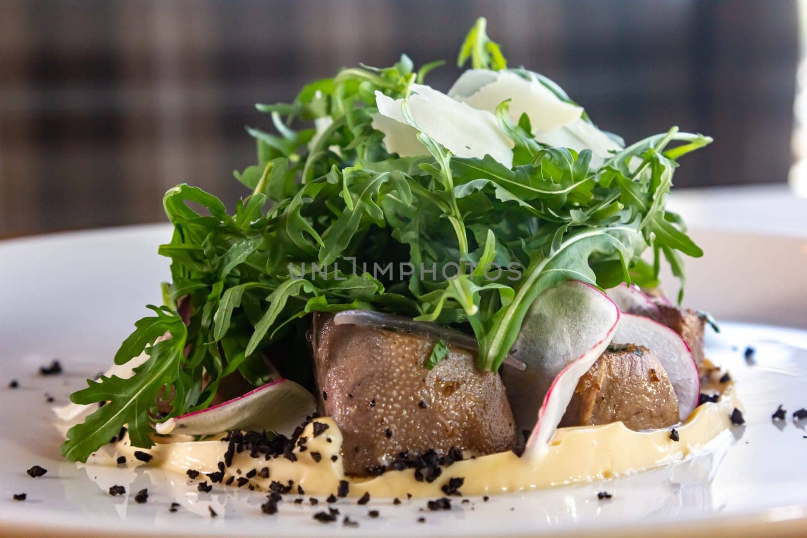 Prepared beef tongue served with mixed green vegetables salad by Milanchikov