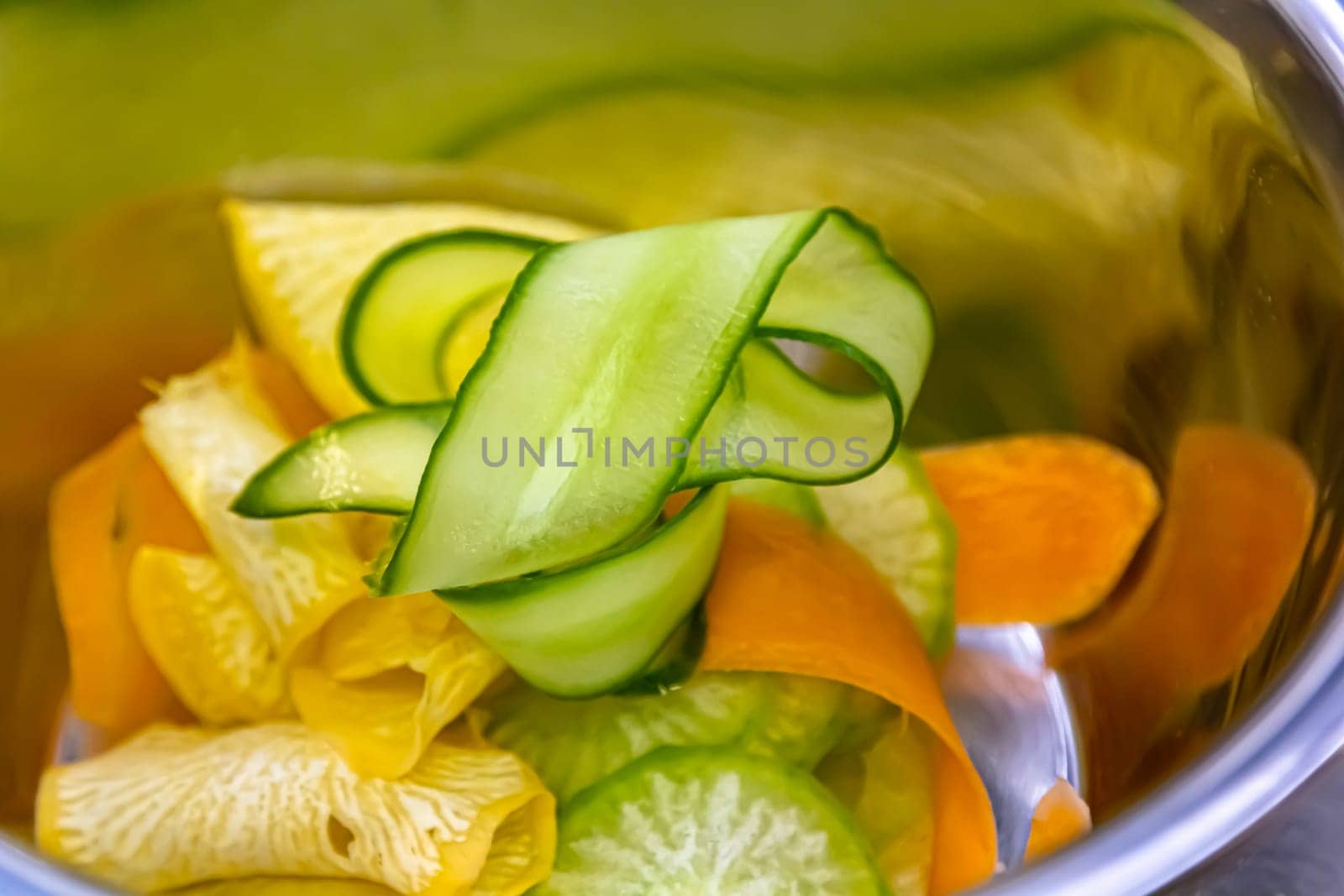 sliced cucumbers, carrots and other vegetables for salad by Milanchikov
