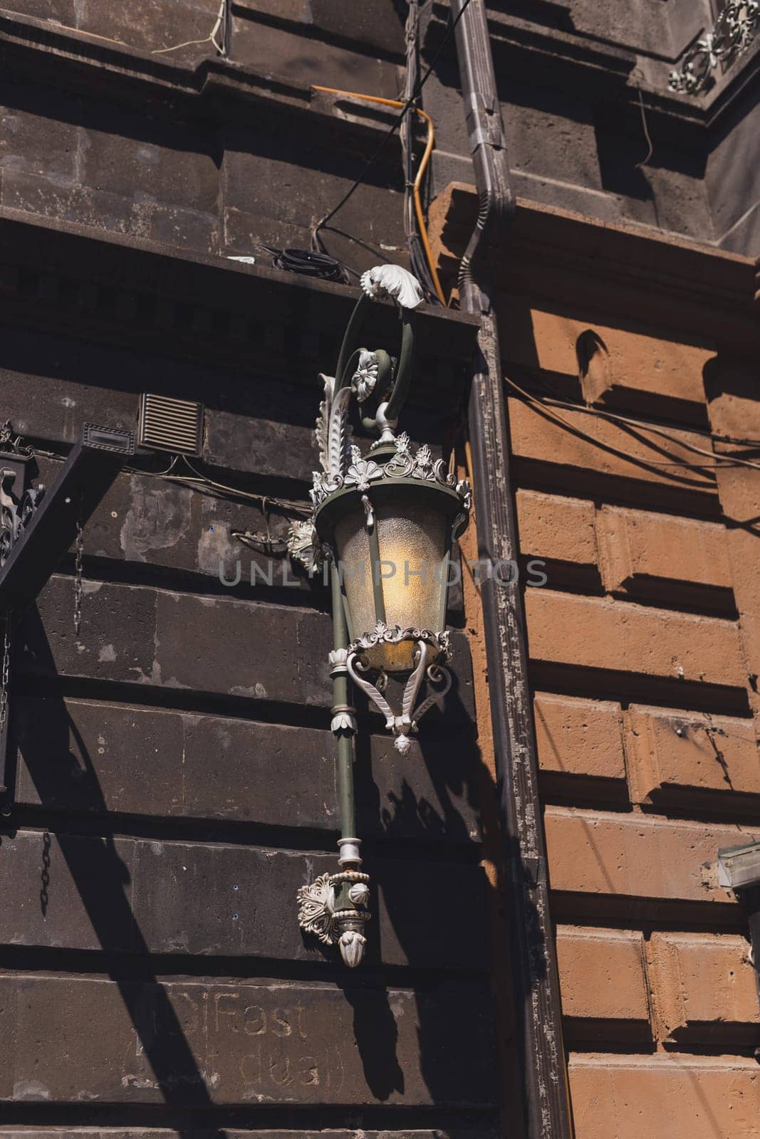 Old fashioned street lamp. Decorative lamps on building in the street by Satura86