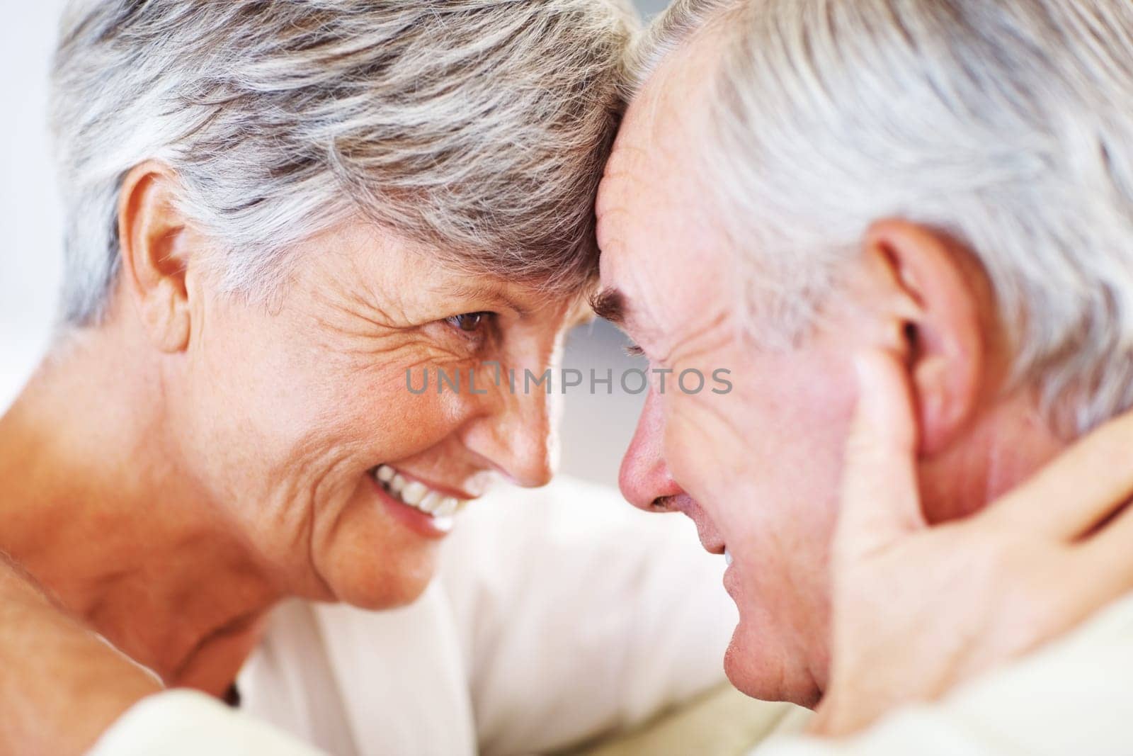 Romantic mature couple. Closeup of romantic mature couple smiling head to head
