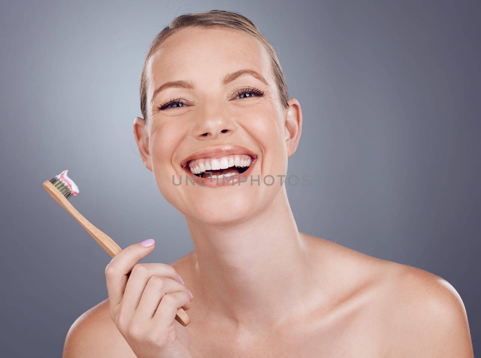 Bamboo toothbrush, happy portrait and woman for dental wellness, healthy cleaning and face cosmetics. Female teeth, eco wooden brush and toothpaste for mouth smile, mature model and studio background.