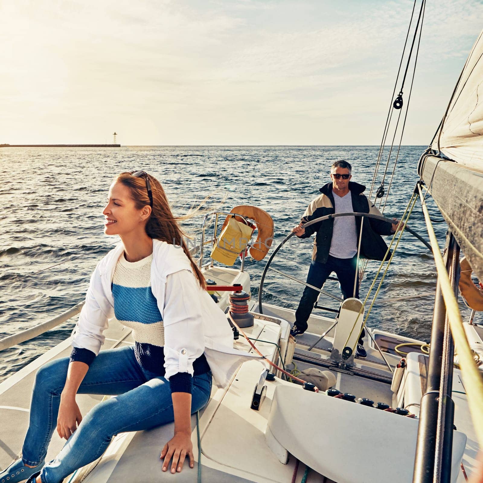 People, ocean and boat on holiday for adventure on transportation with sunshine. Together, yacht and outdoor to cruise at sea for travel with luxury on waves and water during the summer to relax