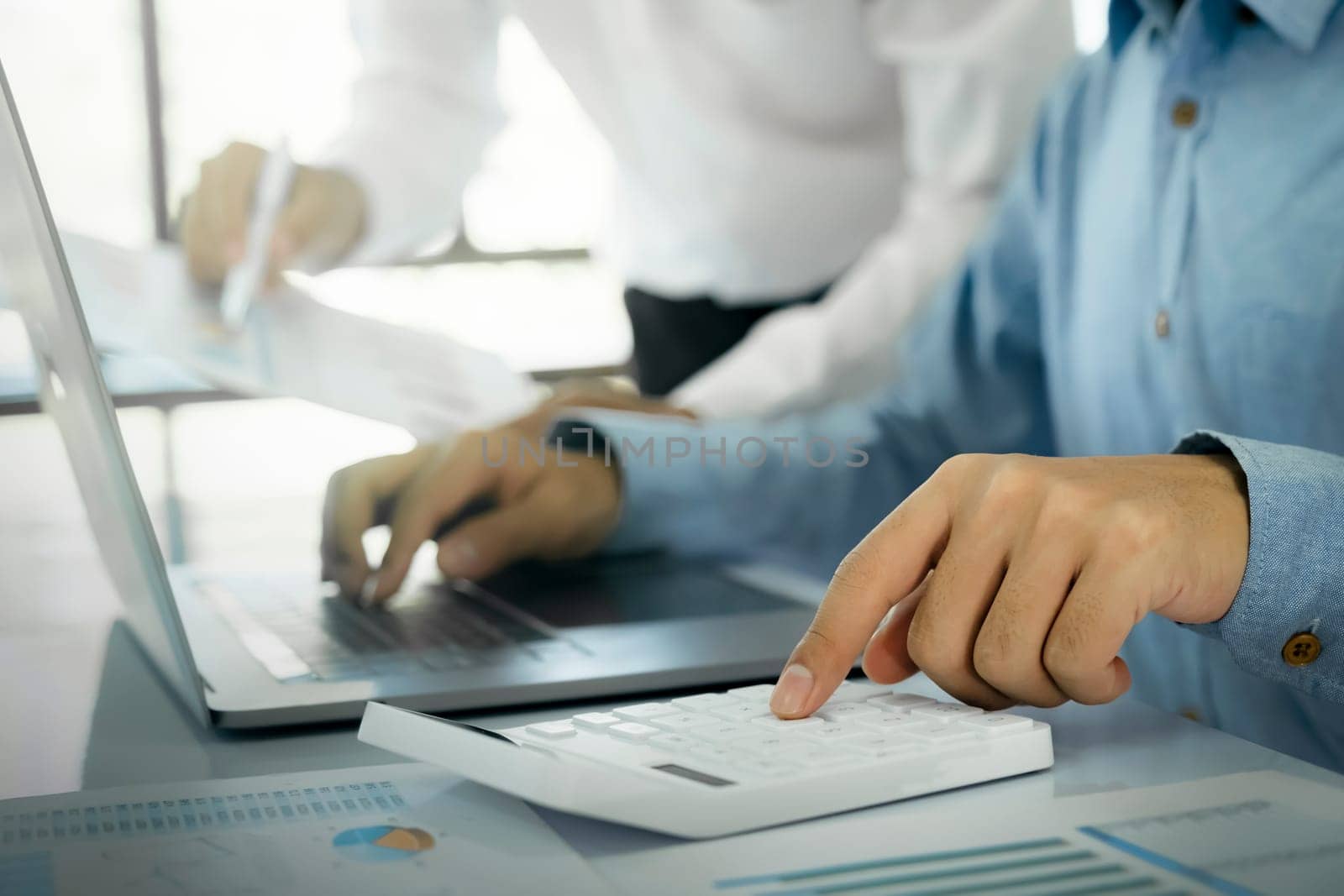 Startup asian business teamwork analyse investment marketing data on computer laptop and use calculator ,finance meeting.