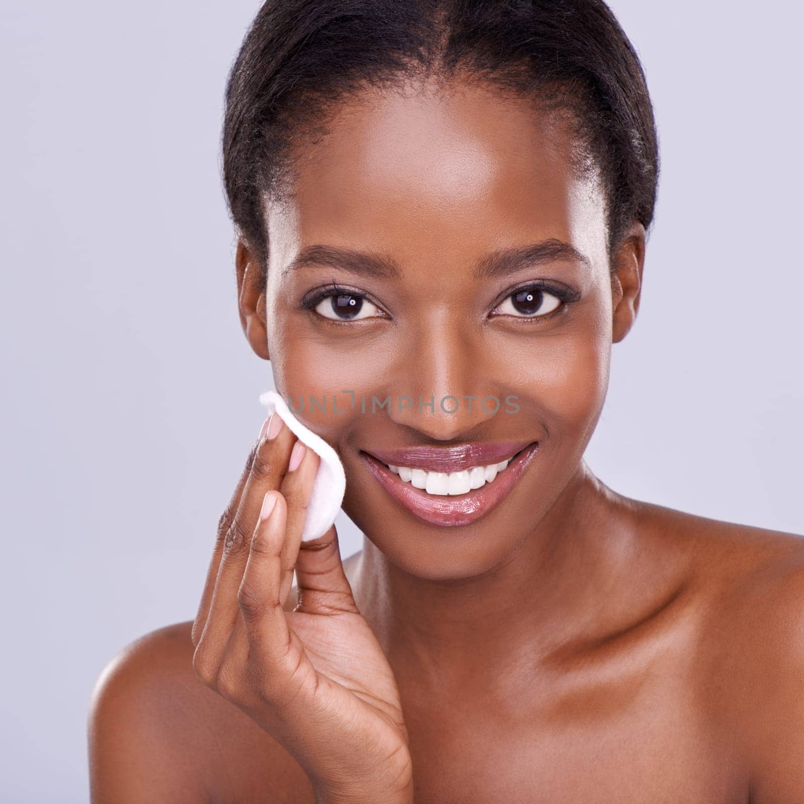 Beauty takes a bit of work. Closeup portrait of an african american woman cleansing her skin