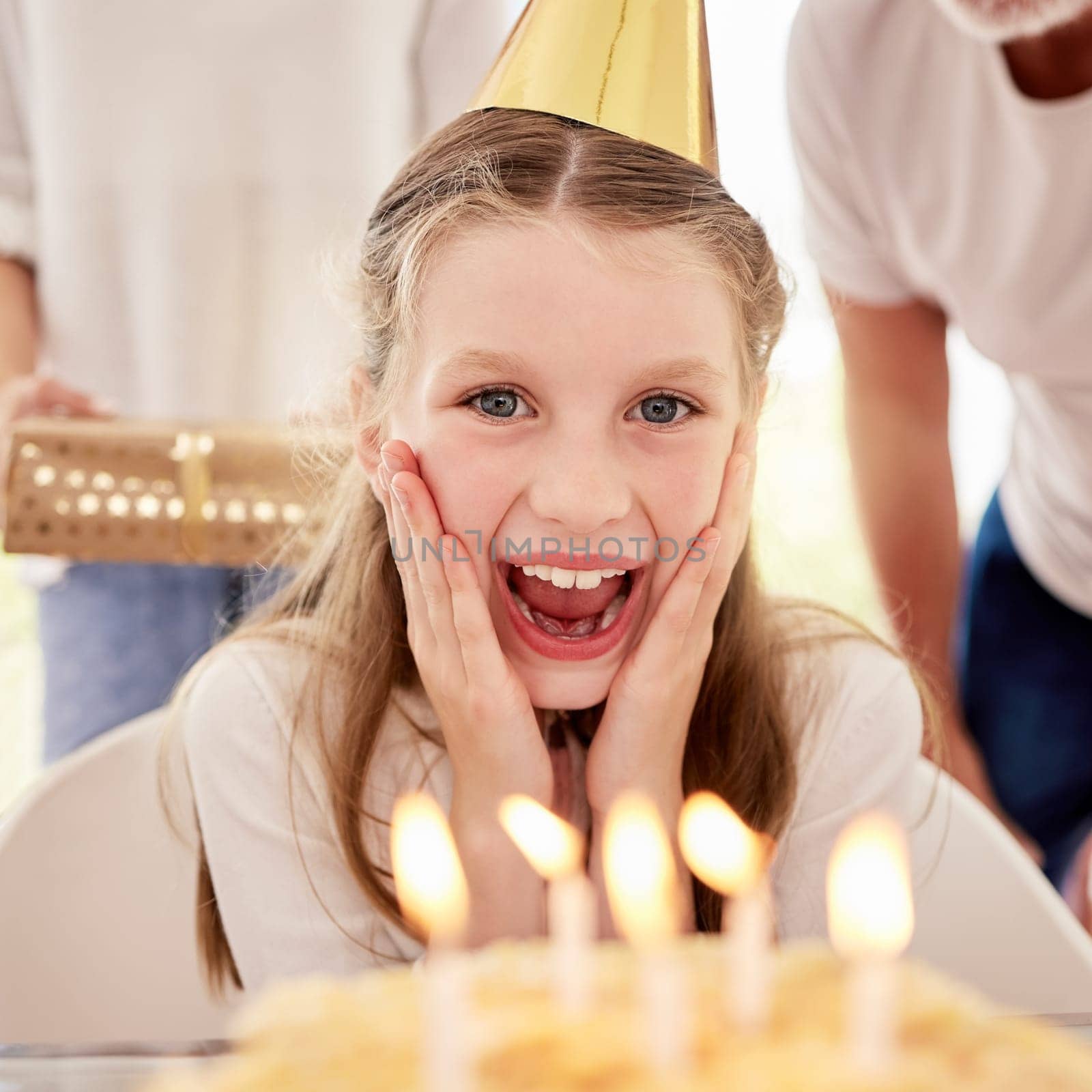 Happy, girl and birthday surprise by candles in celebration, happiness and wow facial expression at home. Portrait of female teenager celebrating special day with family by cake with smile for wish by YuriArcurs