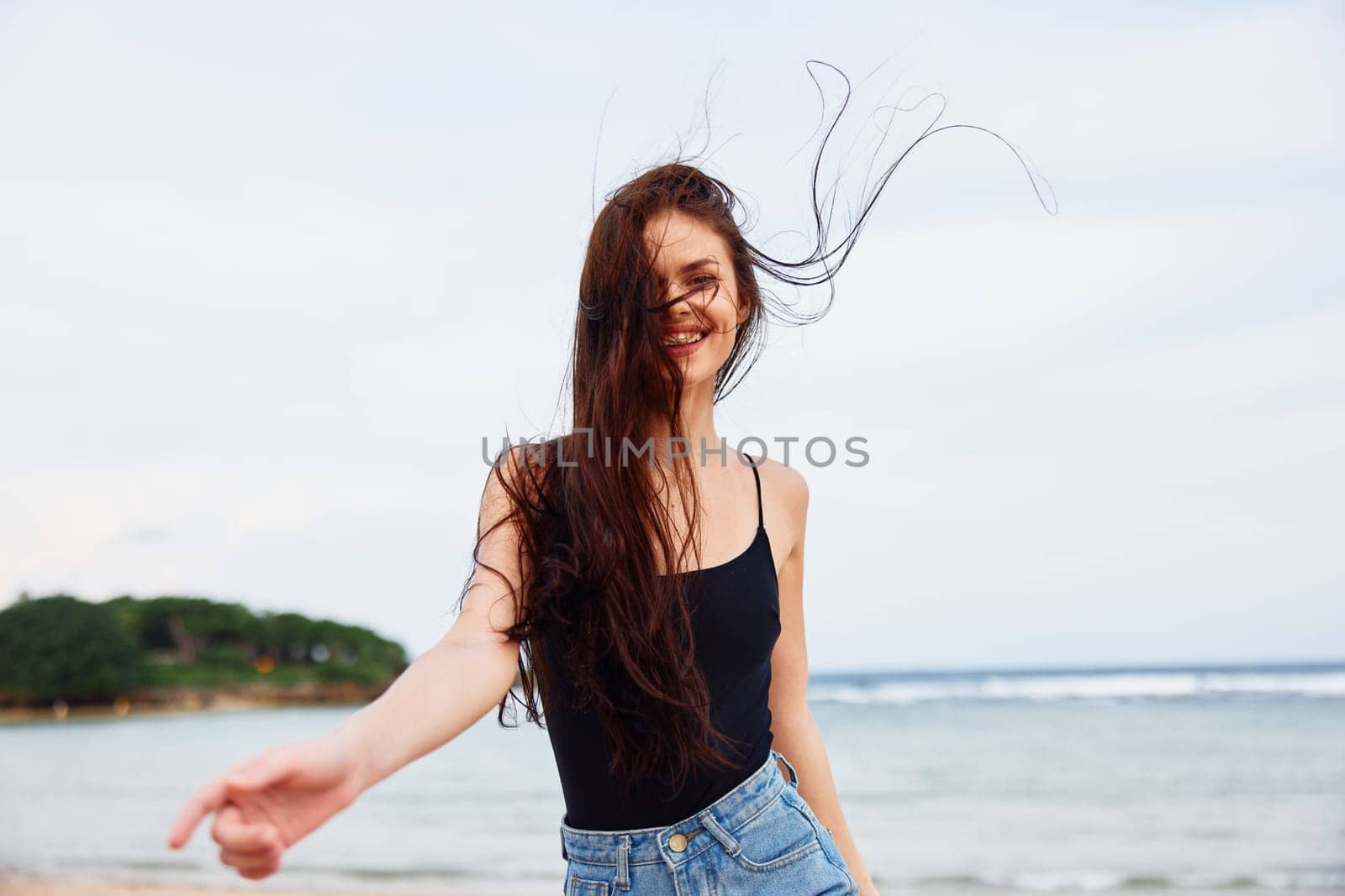 woman young water sunset vacation smiling travel freedom beautiful lifestyle leisure sea running active body smile hair hair summer long beach beauty