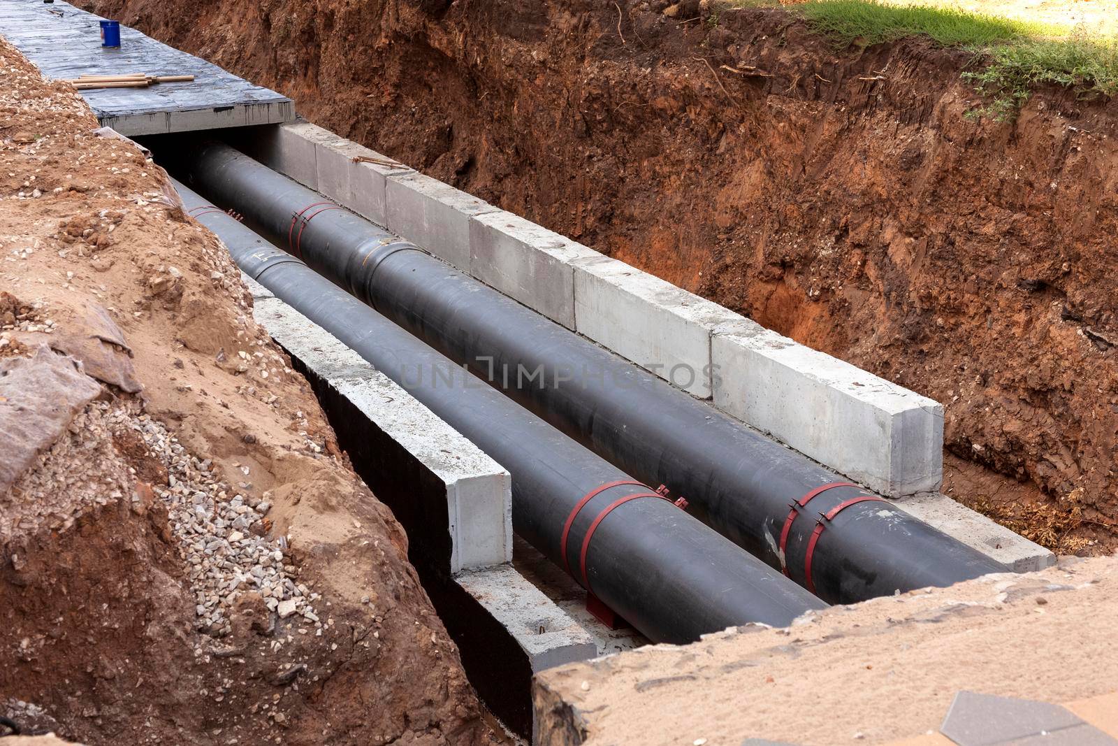 Insulated pipes in the trench. Water main reconstruction and replacement. by Nobilior