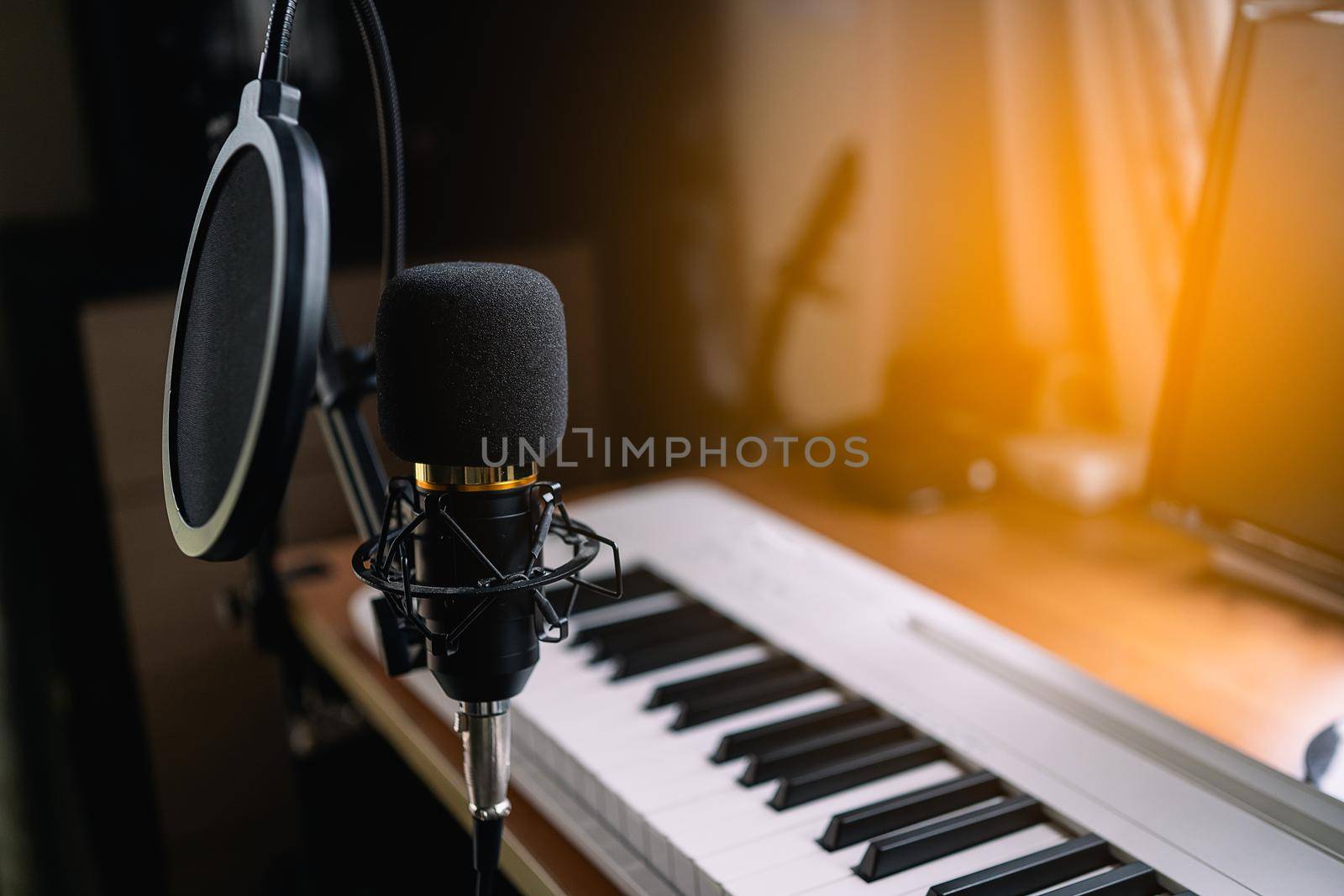 Close up of microphone and piano at the sound recording room by Wmpix