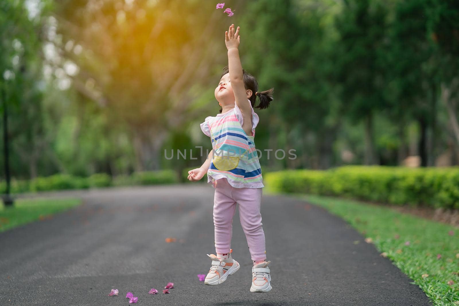 Cute baby playing and jomping at the garden, cute baby outdoor activity concept