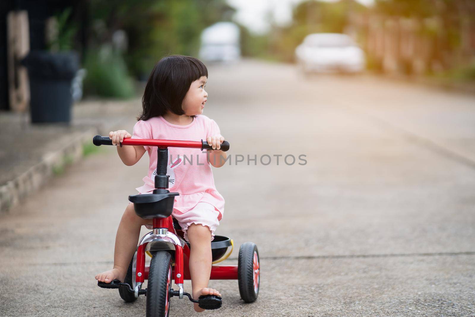 Cute children riding a bike. Kids enjoying a bicycle ride.